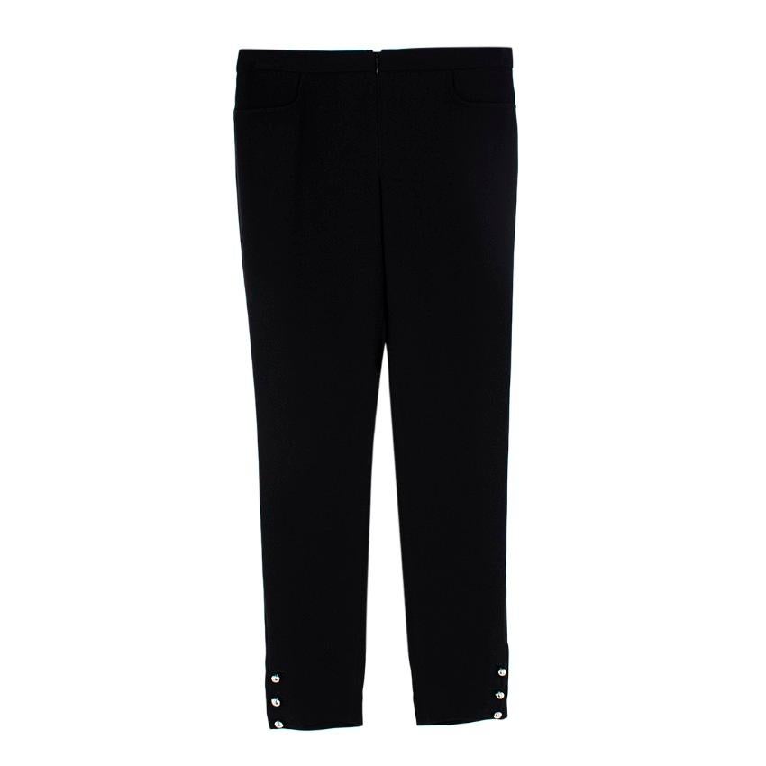  Chanel Black Silk Silver Button Cuff Embellished Trousers

-Lightweight Silk Chiffon
- Concealed zip closure at the front
- Two non-functioning pockets at the front
- Not lined
- Cuffs finished with 3 x silver-tone buttons 

Materials:
100%