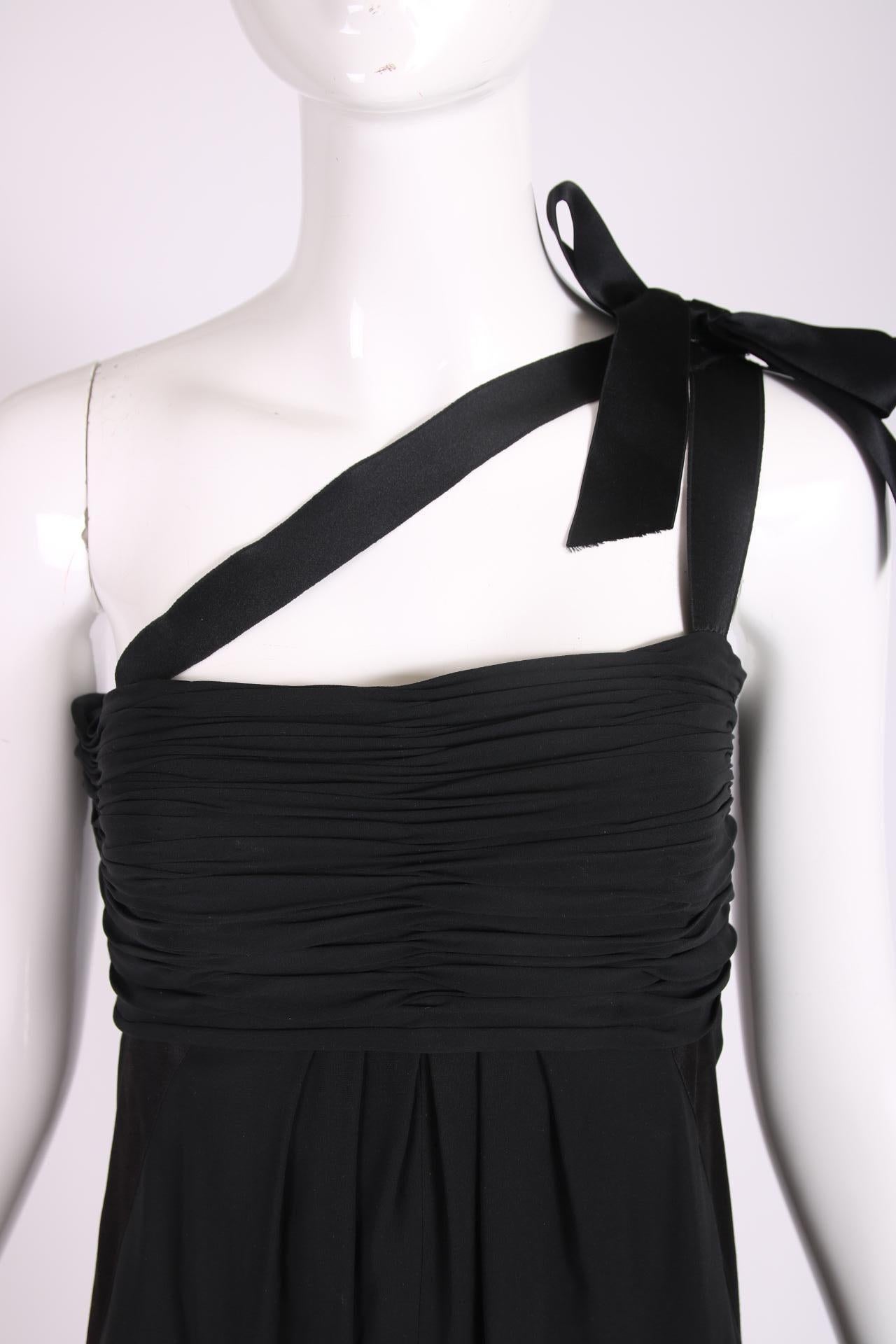 black dress with white bow on shoulder