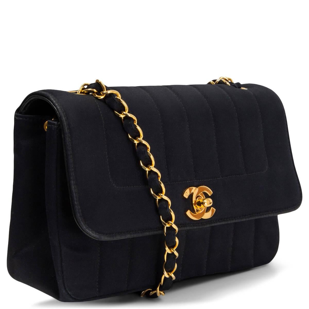 100% authentic Chanel Vintage Diana Shoulder Bag in stripe quilted black satin featuring gold-tone CC turn-lock and classic chain-link shoulder strap. Lined in black lambskin with one zipper and one open pocket against the back. Has been carried and