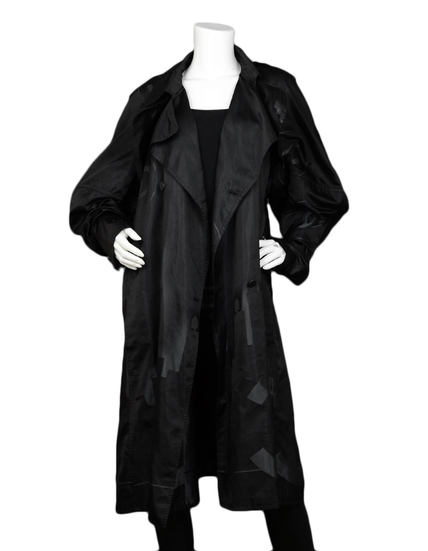 Chanel Black Silk Trench Coat w/ CC Cityscape Design sz 46

Made In: France
Color: Black, grey
Materials: 100% silk
Opening/Closure: Double-breasted button closure
Overall Condition: Very good pre-owned condition, with missing belt
Tag Size: FR46 /