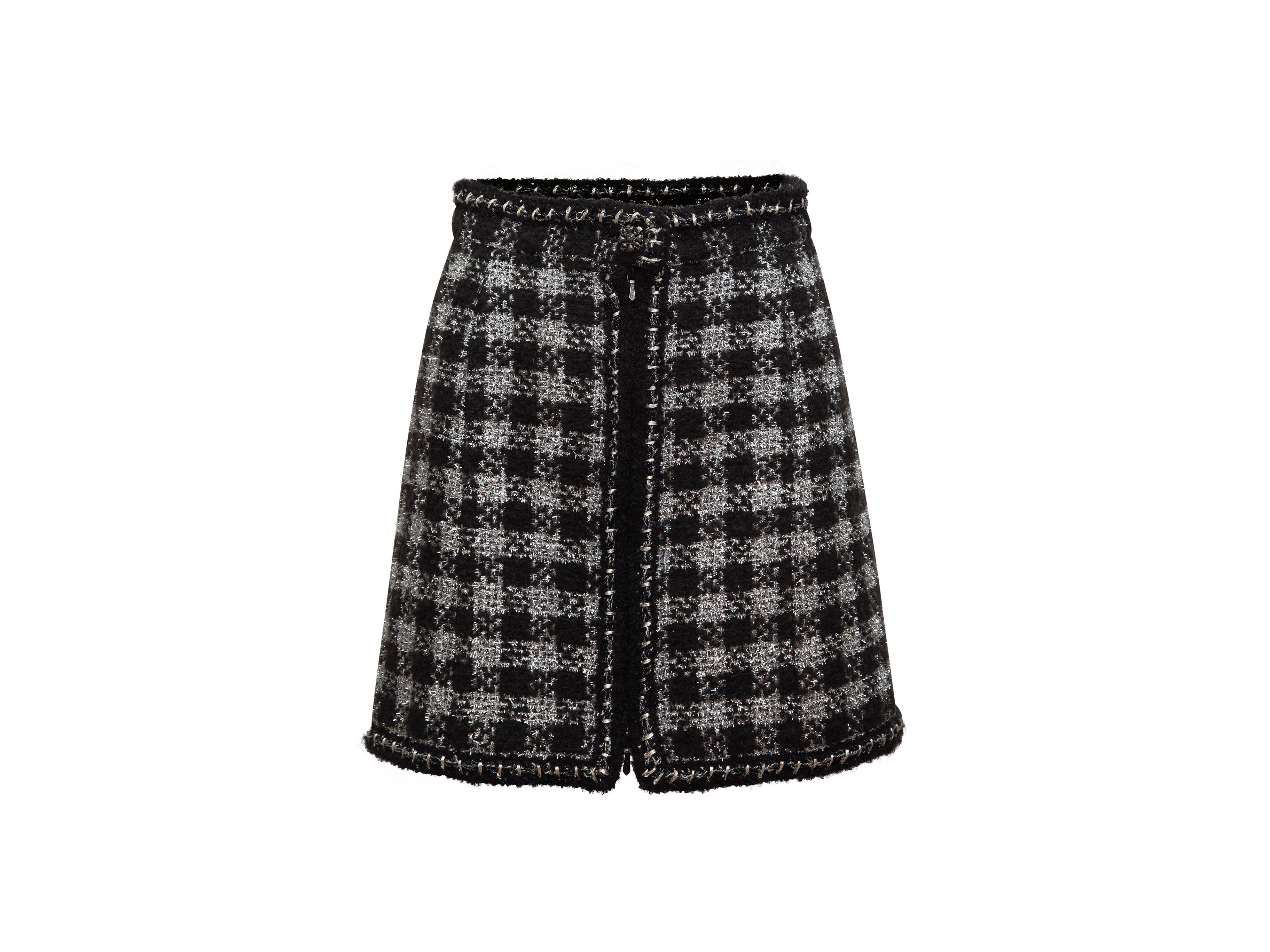 Product details: Black and silver gingham tweed mini skirt by Chanel. Zip and CC button closure at center front. Designer size 38. 26