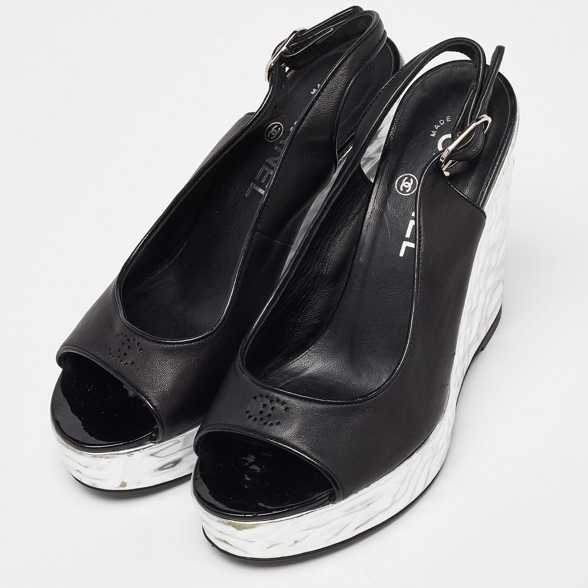 There will always be room in one's shoe closet for a pair of Chanel shoes. We have here a gorgeous pair in black and silver. The open-toe construction is balanced on wedge heels.