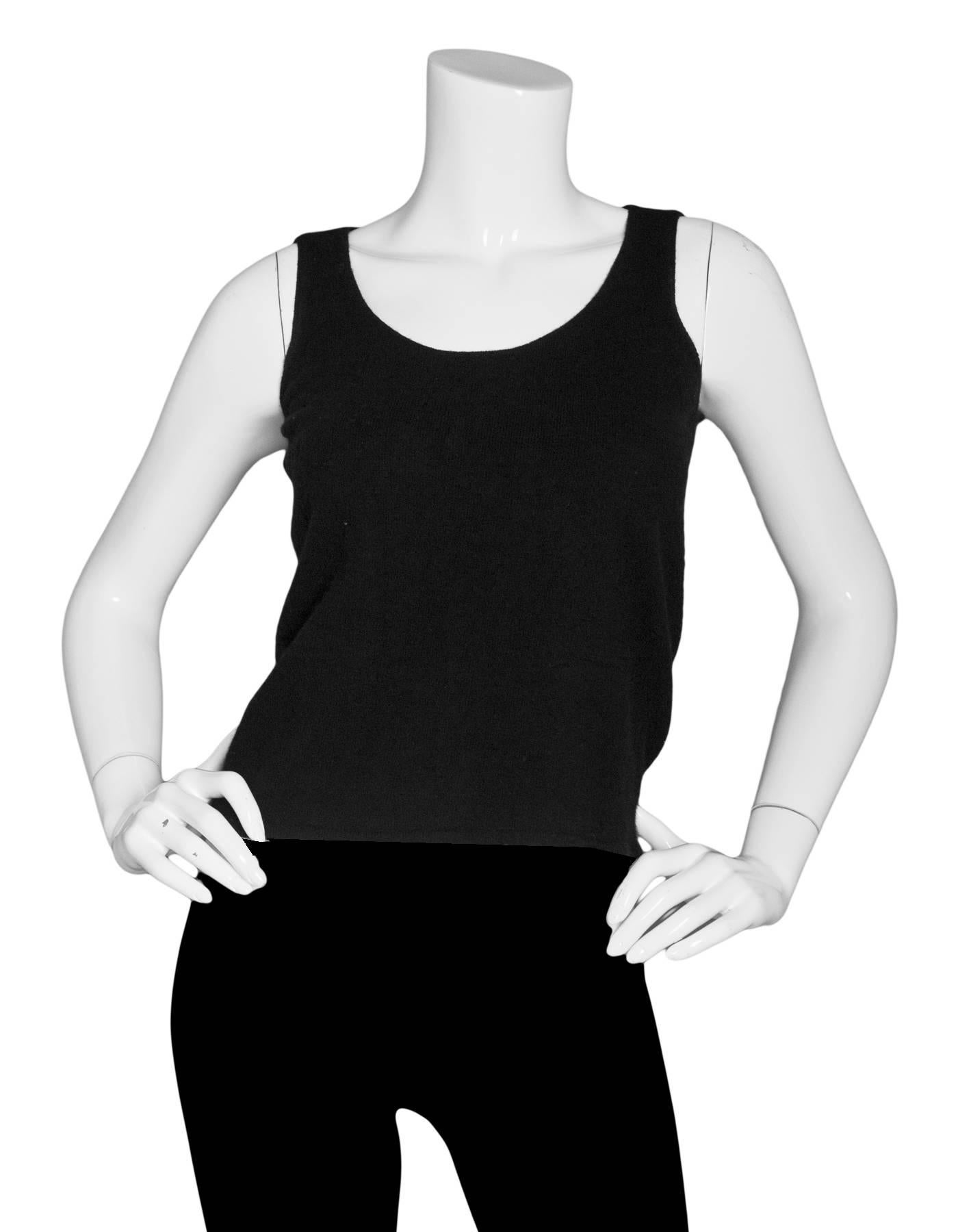 Chanel Black Sleeveless Top

Made In: United Kingdom
Year of Production: 2003
Color: Black
Composition: Illedgable - feels like cashmere
Lining: None
Closure/Opening: Pull over 
Exterior Pockets: None
Interior Pockets: None
Overall Condition: Very