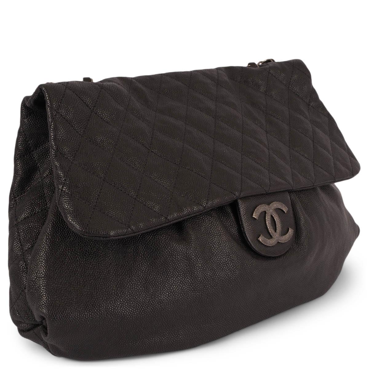 100% authentic Chanel Elastic Flap Maxi Hobo Bag in black Caviar leather with antique silver-tone hardware. The design features a quilted flap and back with one flat back pocket. The bag opens with a magnetic CC logo button to a black satin lined