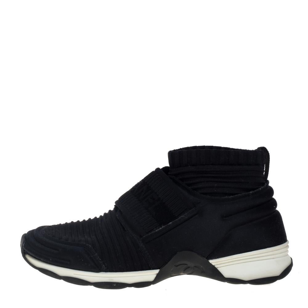 Designed using stretch knit fabric, these sneakers by Chanel are fashioned in a sock style. They bring round toes, logo-detailed straps on the vamps, and the brand logo on the counters. The sneakers are set on rubber soles for all-day comfort.

