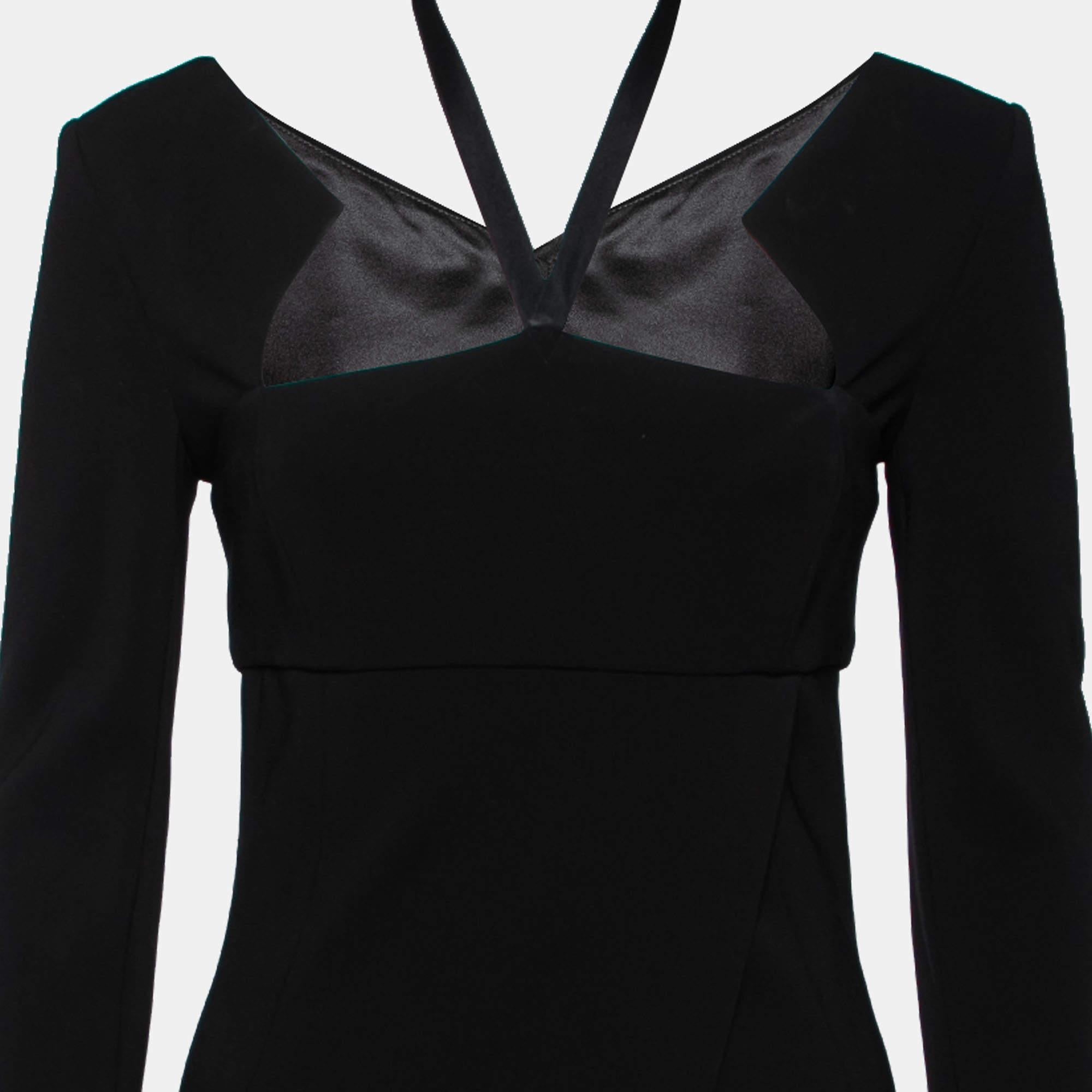 Show your love for understated fashion by donning this elegant dress from Chanel. It comes draped in fine materials with a midi-length and long sleeves. The black dress is truly flattering and has a cut-out detail at the back. It will look wonderful