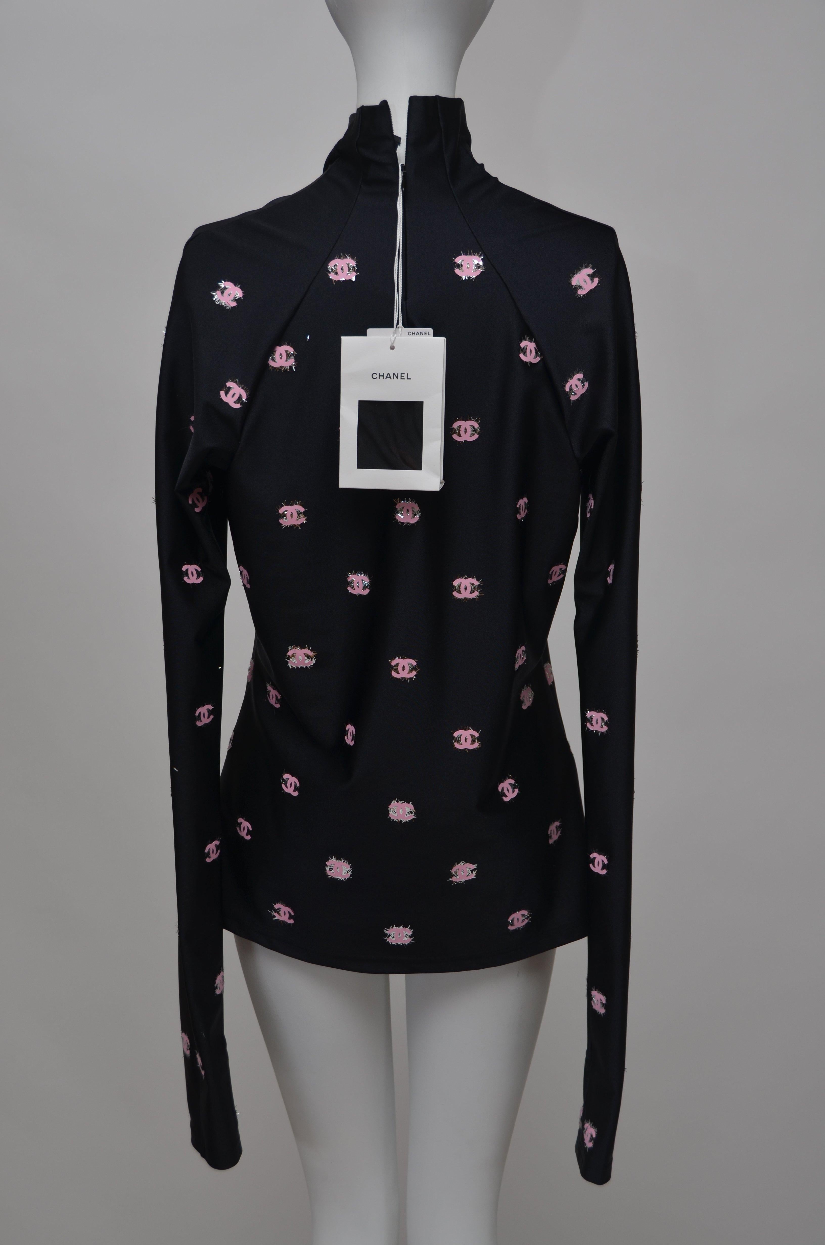 100% AUTHENTIC GUARANTEED  
CHANEL Black Stretch Top With Pink CC 
Long Sleeve   
Bottom of the sleeve have hole for your thumb, very cool
Zipper closure on the back, fabric is light stretchy
SZ 42  
NEW With tags

FINAL SALE