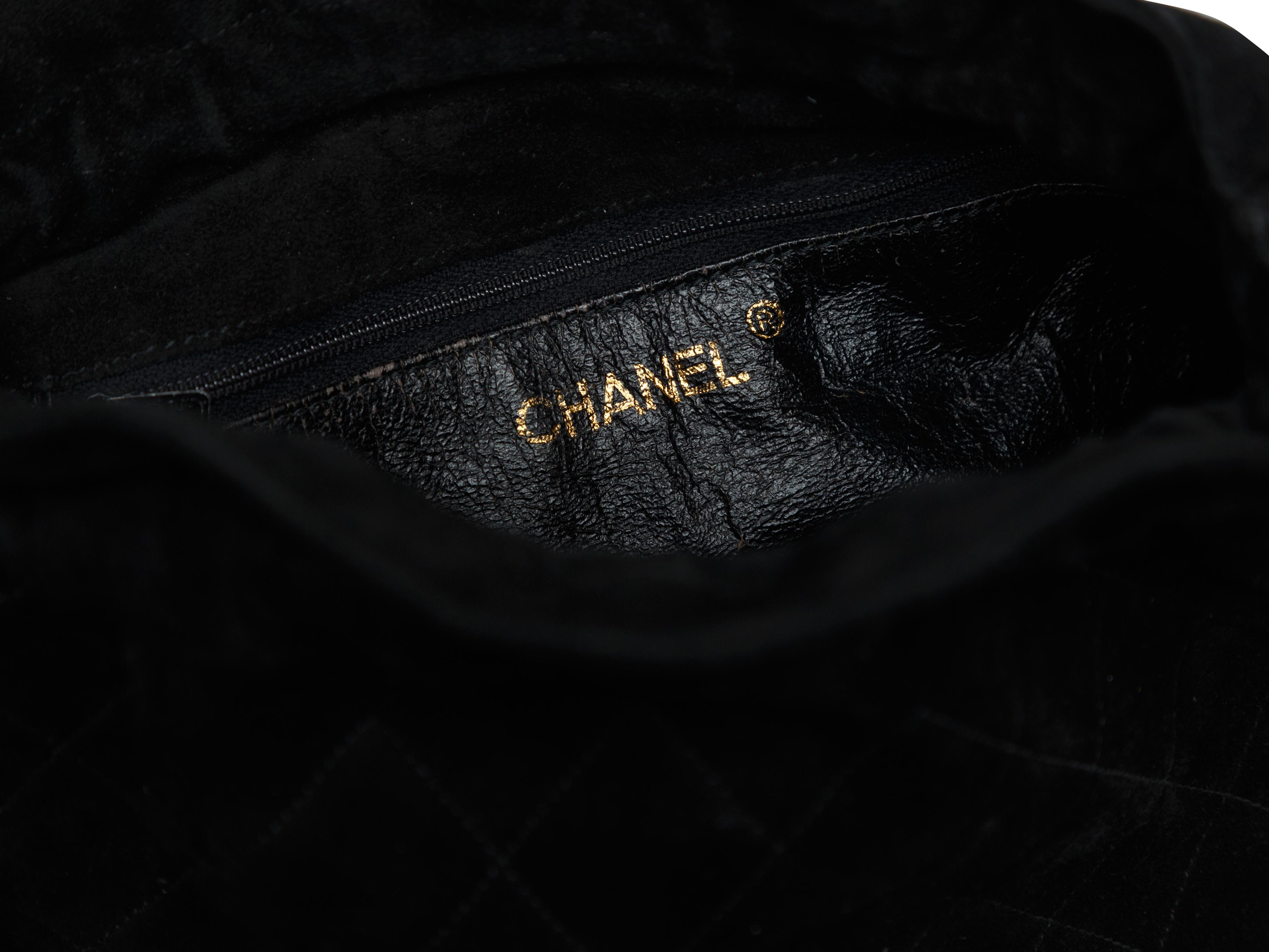 Product details: Vintage black quilted suede leather bucket bag by Chanel. Gold-tone hardware. Chain shoulder strap. 7.5