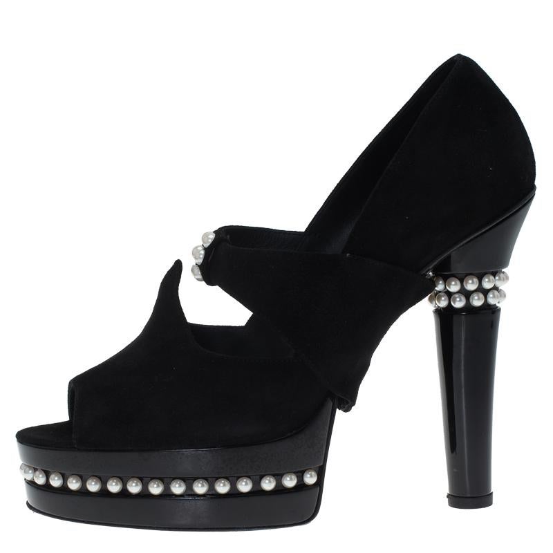 These classy and fashion-forward pumps by Chanel will make a great addition to any wardrobe. They are crafted in black suede with glossy platforms and heels displaying a play of texture and embellishment of faux pearls. The insoles are lined with