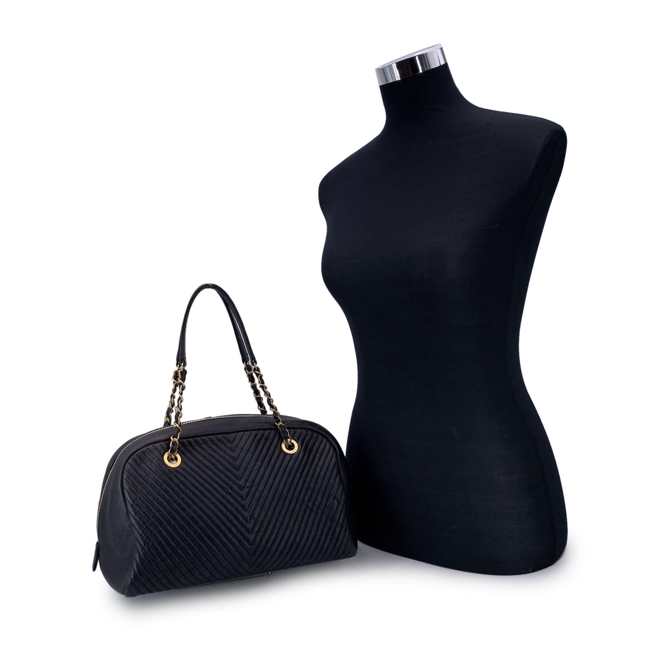 This beautiful Bag will come with a certificate of authenticity provided by third party authenticators. The certificate will be provided at no further cost. Beautiful and elegant black V-quilted leather Surpique Chevron bowling bag by CHANEL.