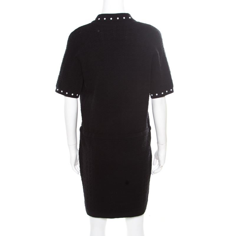 Chanel's expertise in designing clothing that is wearable and comfortable without compromising on style includes this black dress. It is well knit in a textured design and has faux pearl embellishments and a string that can be tied to give the dress