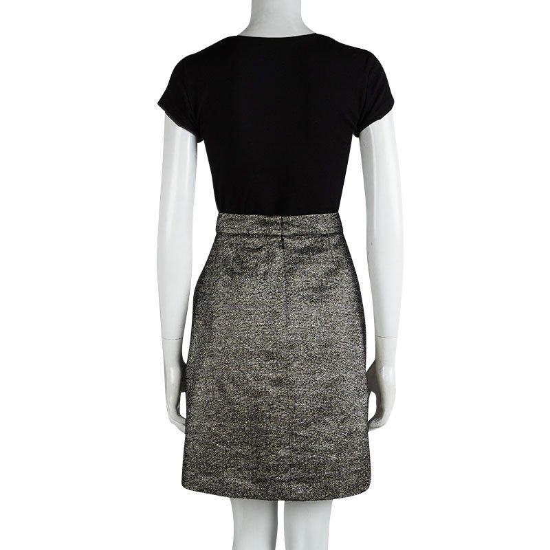 A classic style from Chanel is a summer staple. The textured metallic skirt in black is constructed with an A-line silhouette, a back zipper fastening and darts for great fit! Wear this your office blouses and tops.

Includes: Price Tag,The Luxury