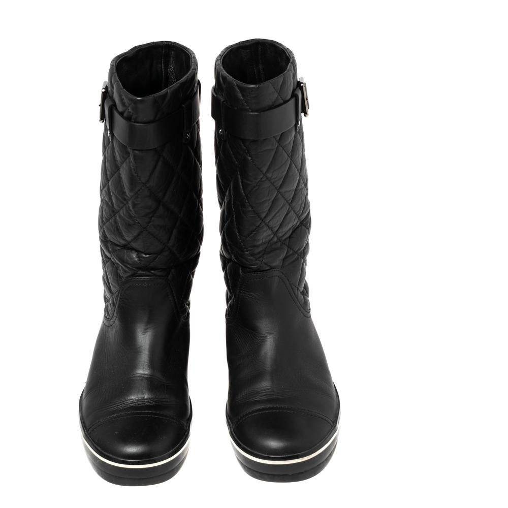 Stay on style with this pair of black boots from Chanel! Beautifully crafted from textured quilted leather, these mid-calf boots carry round toes, leather insoles, and belt details. Waltz around town in this lovely pair!

Includes: Original Dustbag
