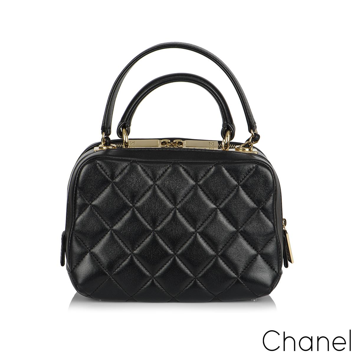 A stylish black Chanel Trendy CC Bowling Bag. The exterior of this Trendy CC Bowling bag is crafted with black lambskin leather in the signature diamond style stitching with gold-tone hardware. It features a front open pocket and two zipper