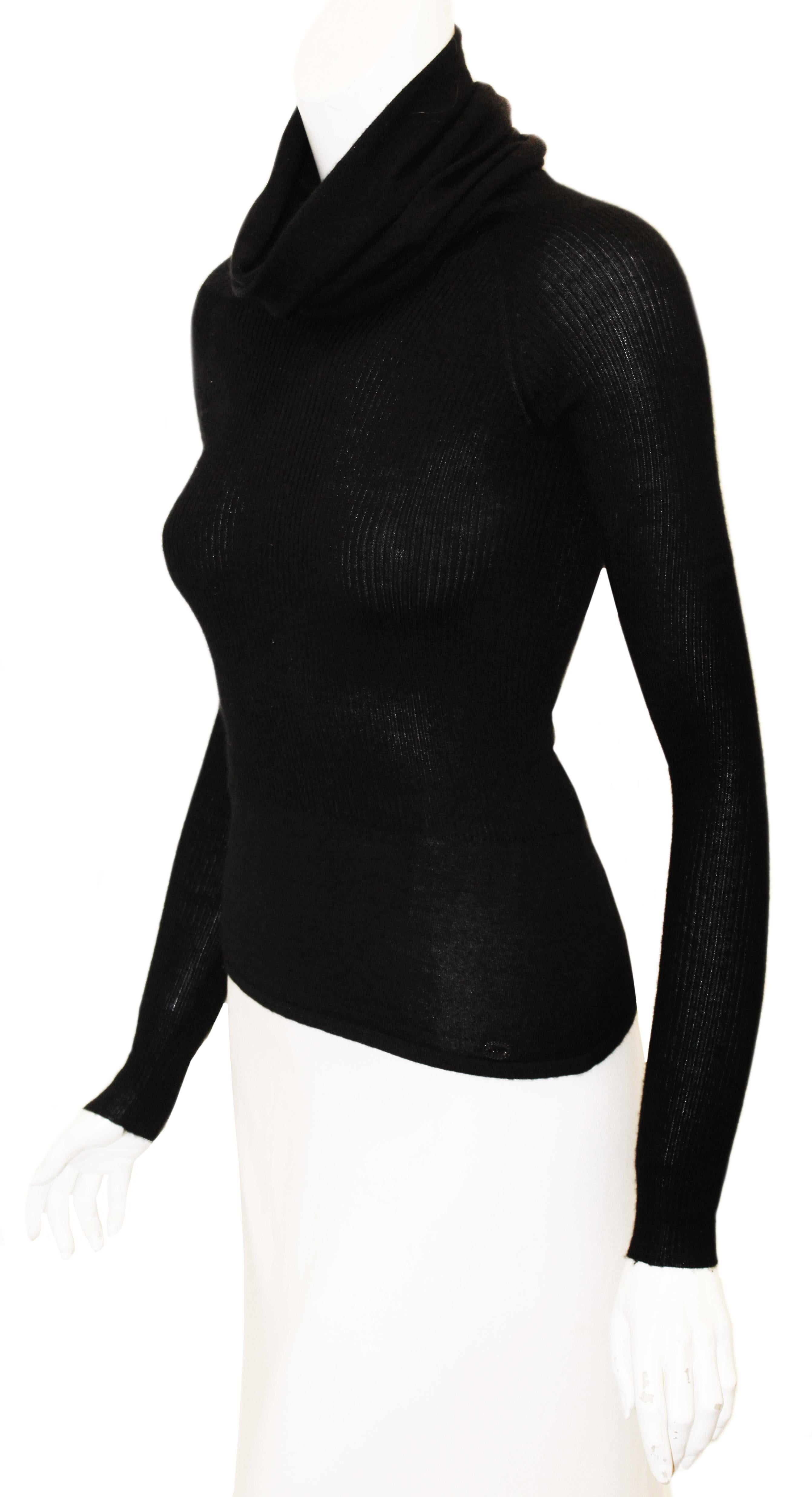 Chanel black long sleeve turtleneck cashmere and silk pullover sweater is from the fall 2005 collection.  This long turtle neck collar will keep you warm and comfortable on those cool spring days or nights with its soft cashmere texture.  The body