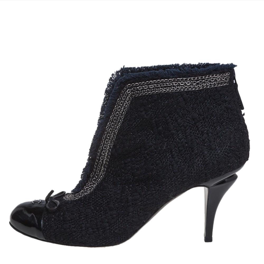 These ankle booties from Chanel have been designed to present a fashion-forward appeal. The booties are covered in tweed and designed with little bows, patent leather cap toes detailed with the CC logo, and 9 cm high heels.

