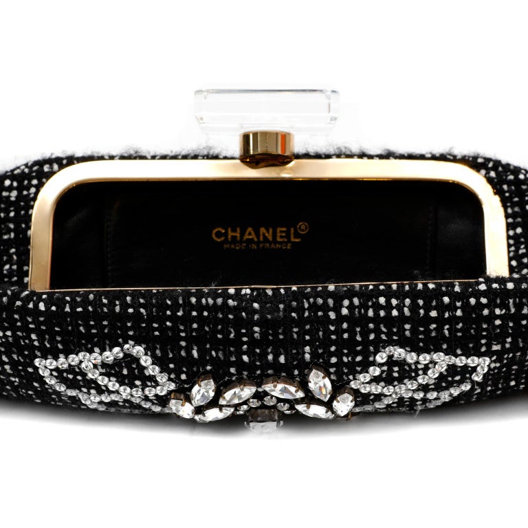 This authentic Chanel Black Tweed and Rhinestone Runway Clutch is in pristine condition.  Enhanced with ornate crystals and a Lucite clasp, this spectacular piece from the 1990’s is a fantastic addition to any sophisticated collection. Black and