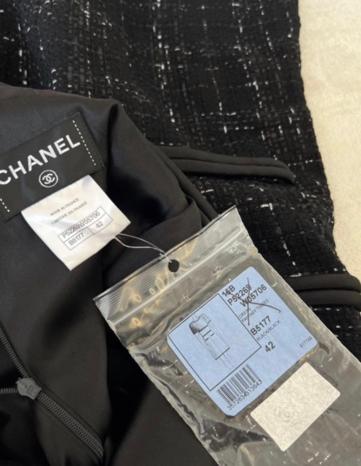 Chanel black tweed dress with CC logo charm at pocket.
Size mark 42 FR, tags attached