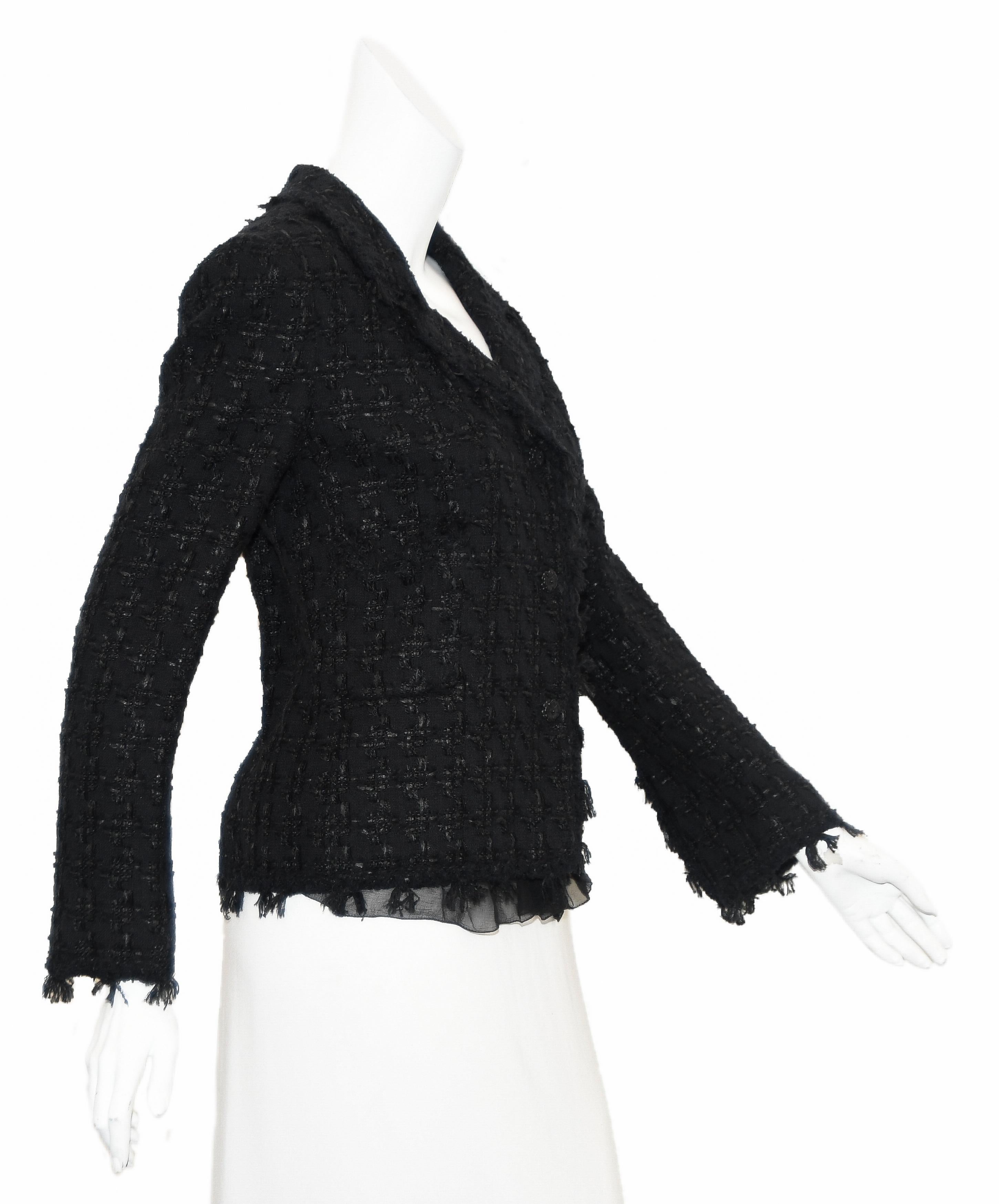 Chanel black tweed from the 2005 cruise collection with fringe trim all around the jacket including the notch collar, cuffs, front opening and hem.   This flirty jacket incorporates 2 patch pockets at the side, one pocket contains a CC Chanel