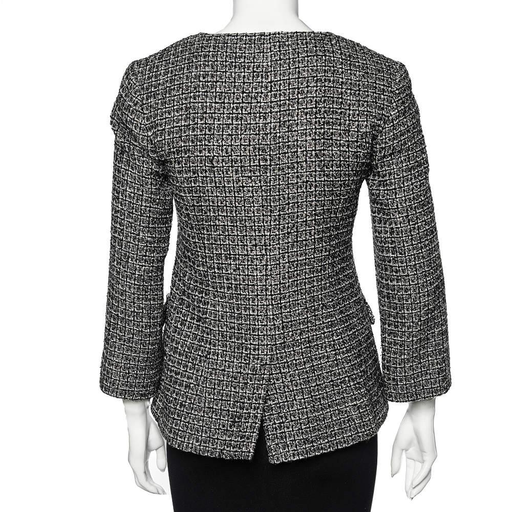 Known for creating luxurious, one-of-a-kind designs, the House of Chanel is back with this another stunning piece. This jacket from Chanel exudes signature charm and excellence with hints of sparkle! It is fashioned in black tweed fabric, which is