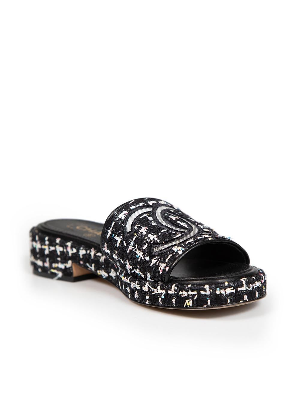 CONDITION is Very good. Minimal wear to sandals is evident. Minimal wear to the top, back and sides of both shoes where pulls to the weave can be seen on this used Chanel designer resale item.
 
 Details
 Black
 Tweed
 Slides
 Open toe
 Embroidered