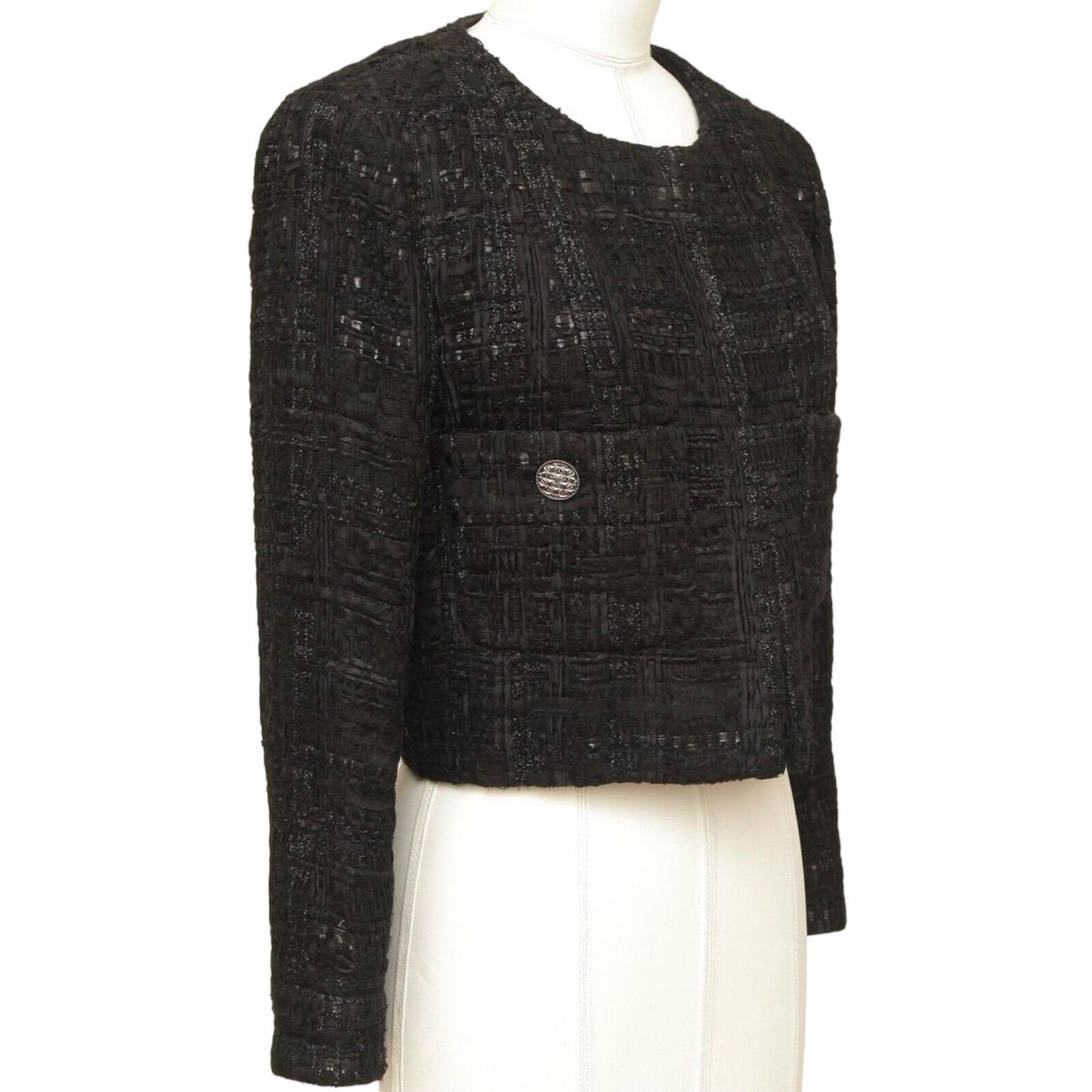 GUARANTEED AUTHENTIC CHANEL PARIS-DUBAI 2015 FANTASY TWEED BLACK JACKET

Retail excluding sales taxes $6,750.

Details:
• Signature cut and fit on this unique black open front jacket, 3 covered hook & eye closure.
• Collarless.
• Gunmetal button at
