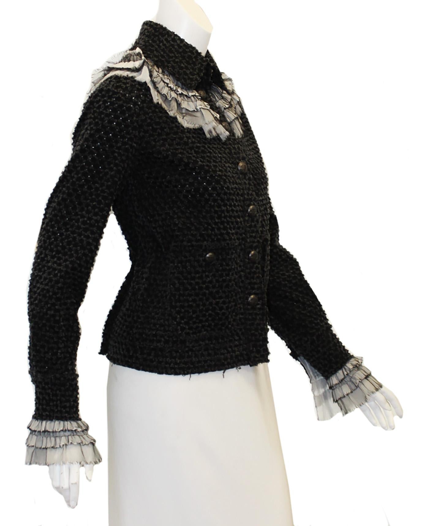 Chanel black tweed jacket includes a white multi layered pleated ruffle collar and cuffs, very regal.   This single breasted jacket incorporates  7 pewter tone CC buttons at front, for closure and same buttons on the two patch pockets.  This jacket