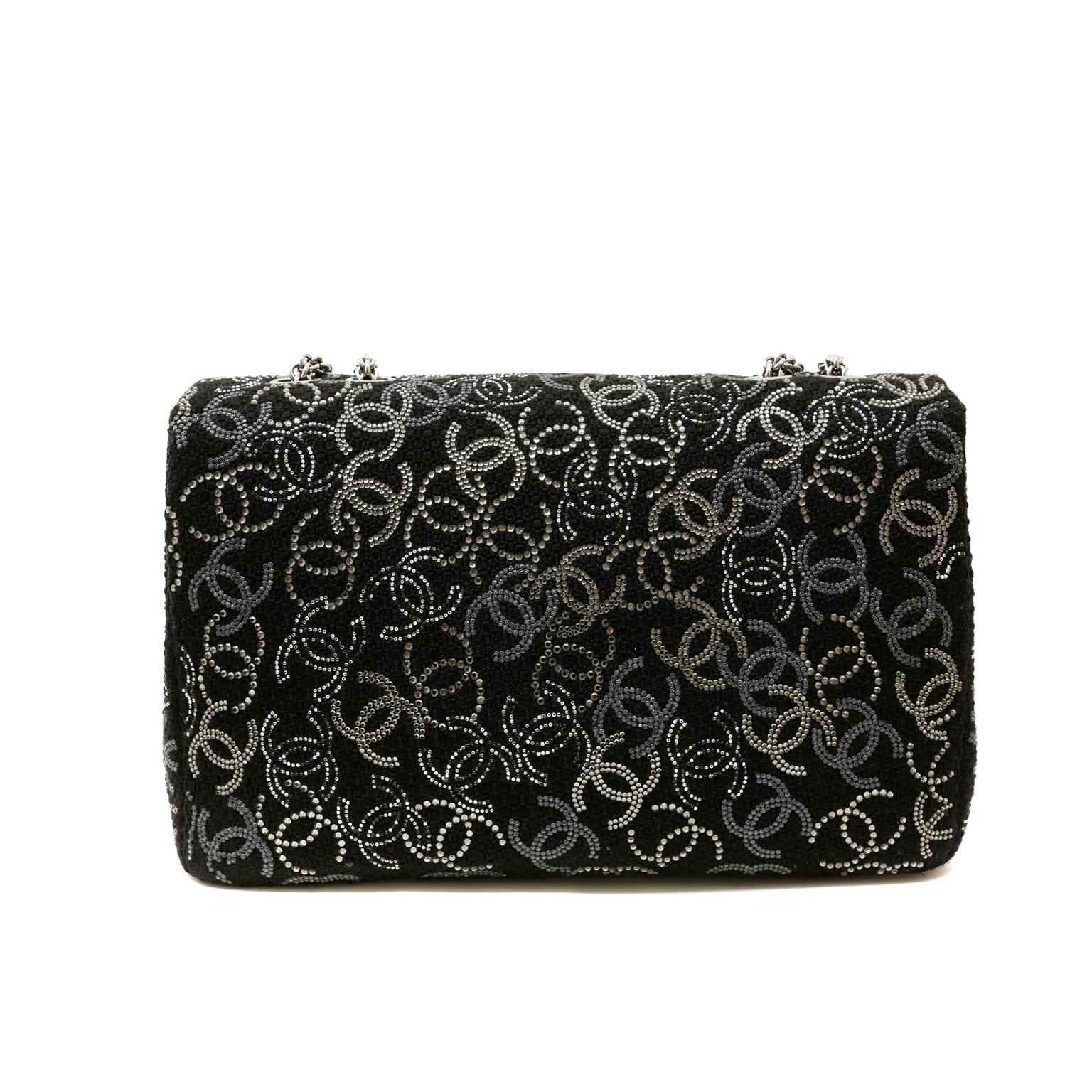 This authentic Chanel Black Tweed Swarovski Crystal Jumbo Classic is in pristine condition.  From the 2010 collection, this exquisite single flap bag makes a great addition to any collection. 
Black tweed fabric single flap bag is covered in