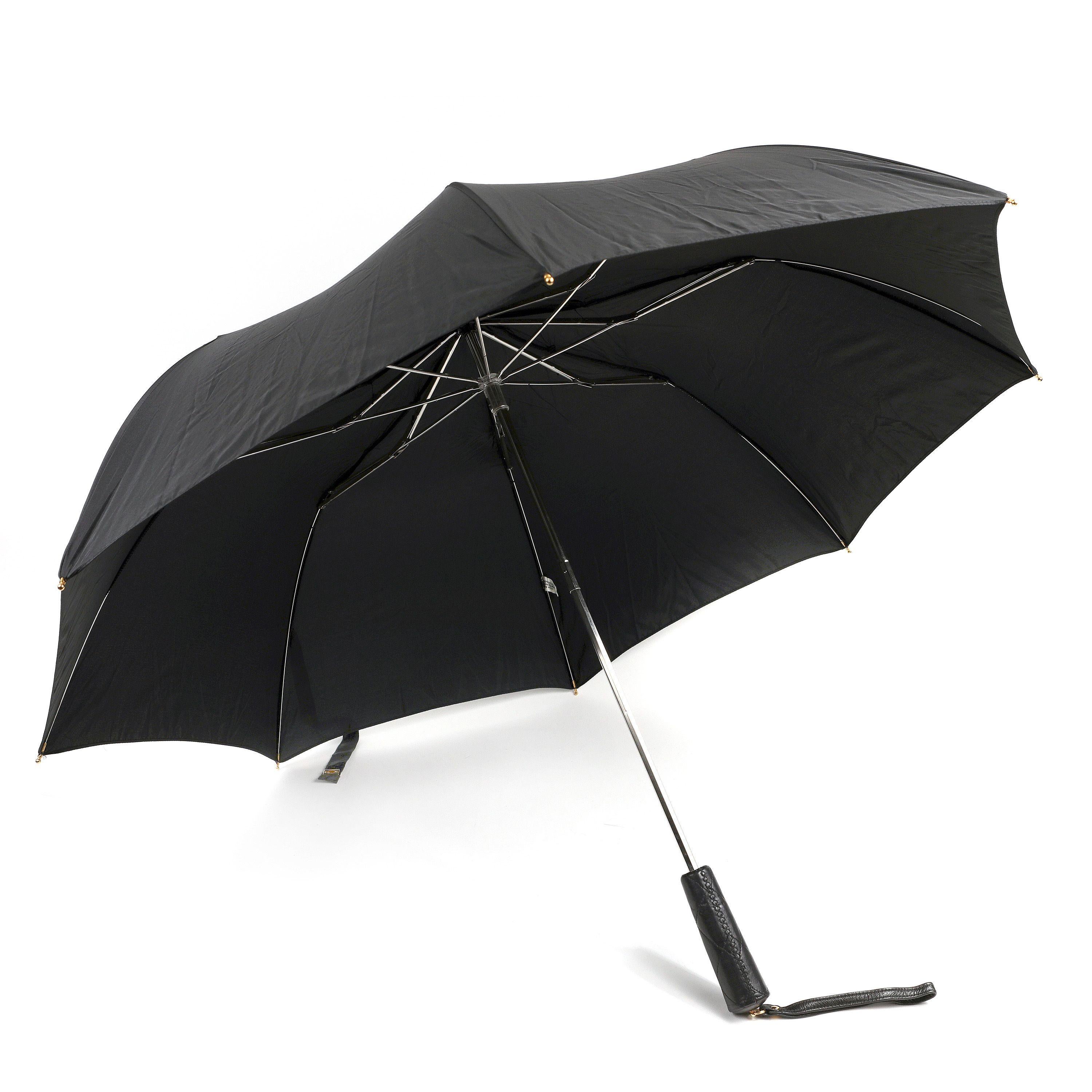 This authentic Chanel Black Umbrella and Case is pristine.  Classic black umbrella with gold interlocking CC clasp and leather handle.  The coordinating quilted case has a long leather and chain entwined strap to maintain chicness in all kinds of