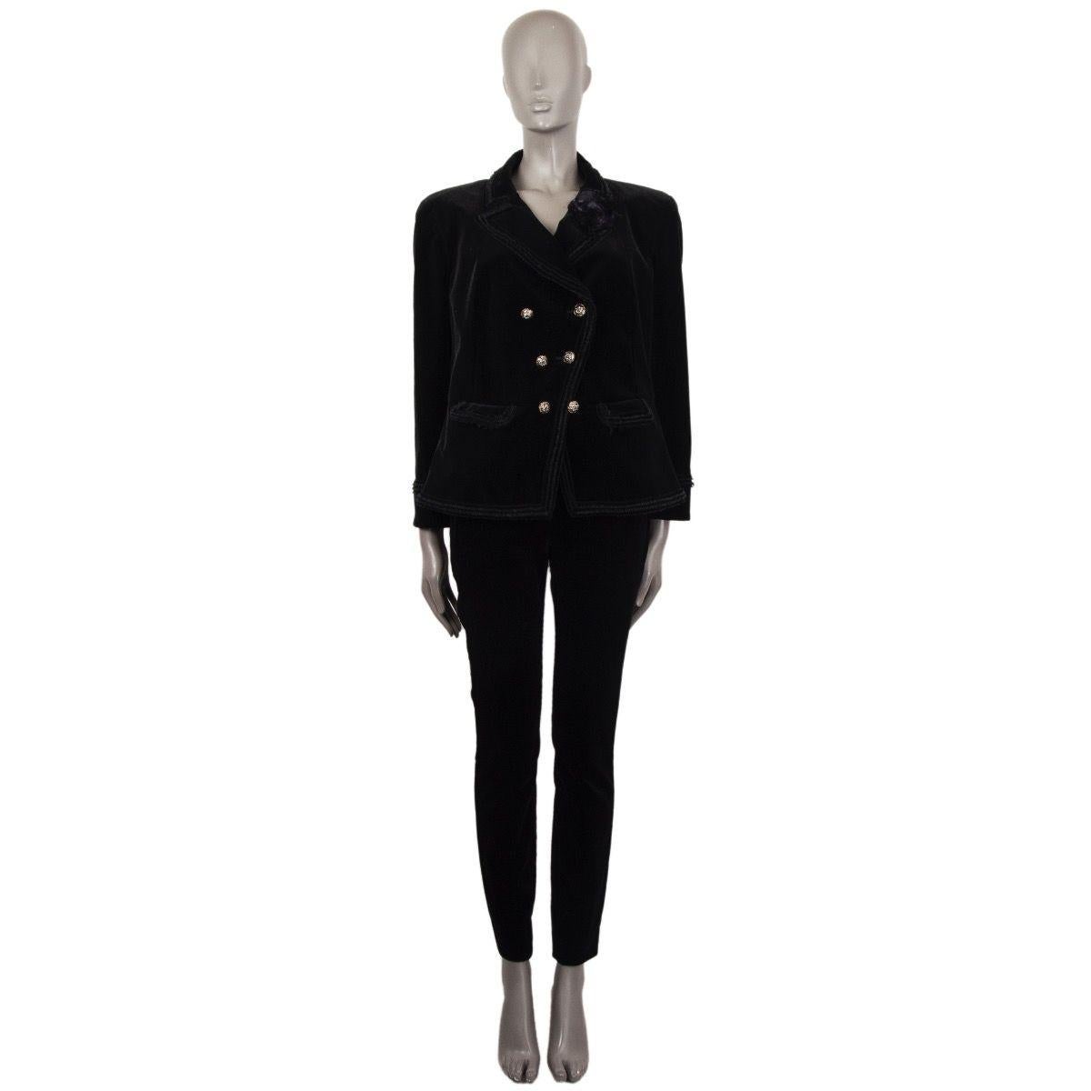 CHanel double-breasted velvet blazer in black ctoon (99%) and elastane (1%). With peak collar, short.fringe trims, two flap pockets on the front, and diagonal front seam, Closes with embellished CC buttons in antique gold, black and white metal and