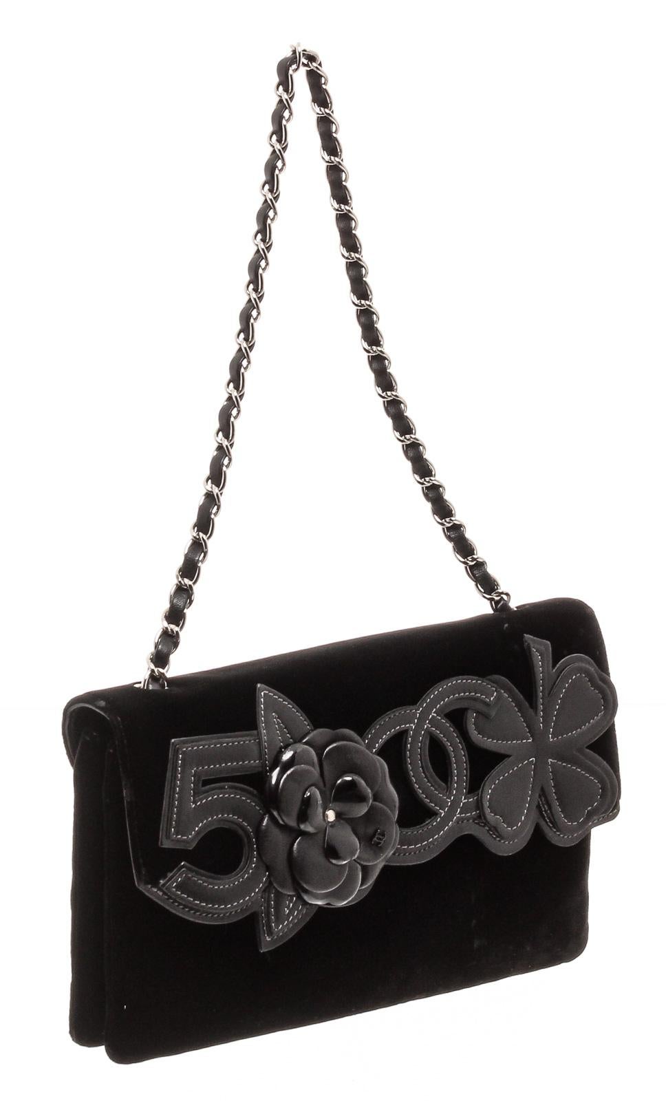 Black velvet Chanel Precious Symbols Flap Bag with ruthenium hardware, tonal lambskin trim, single woven chain-link shoulder strap, Precious Symbols appliqués at front flap, dual interior compartments, tonal logo jacquard lining, single zip pocket