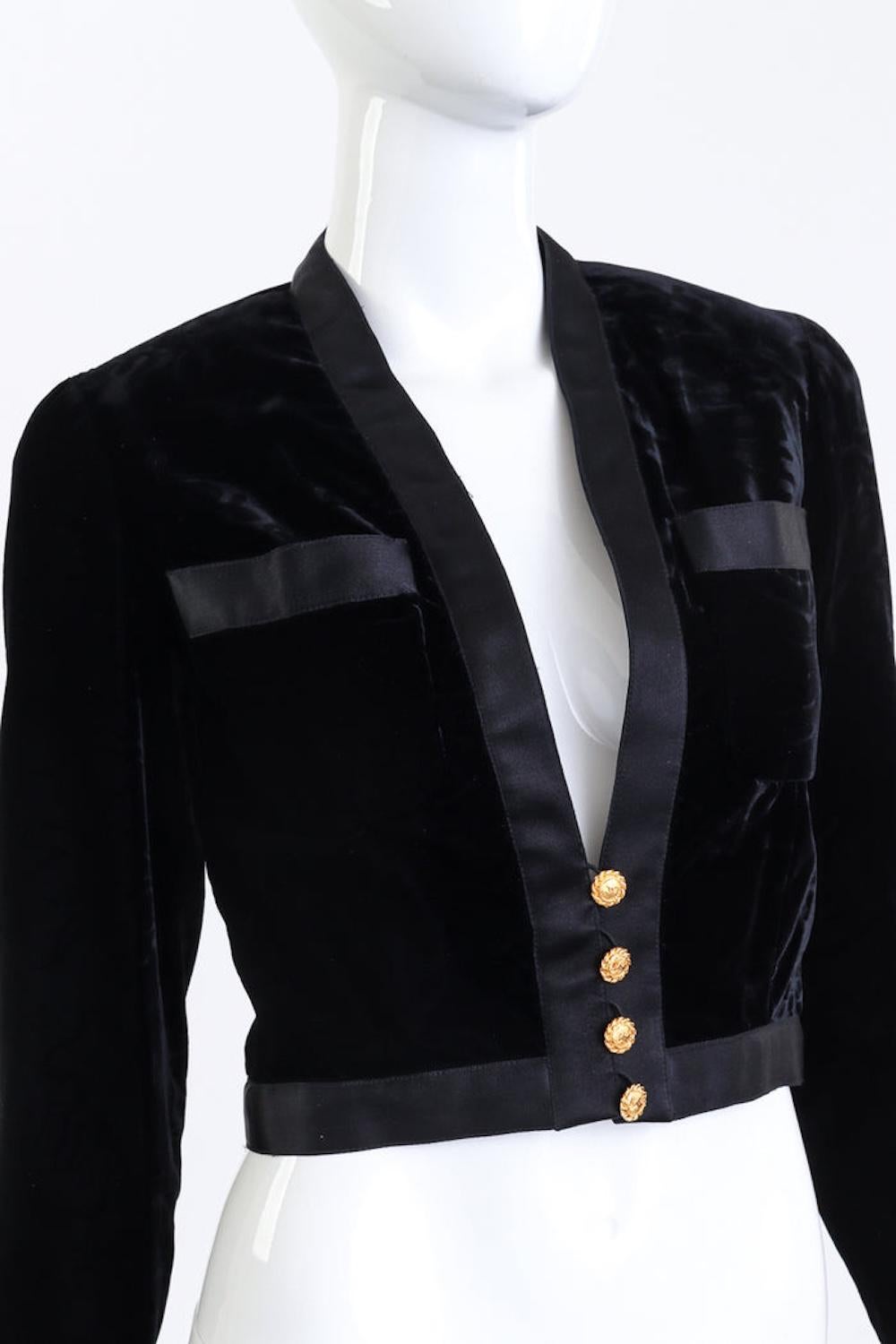 CHANEL BLACK VELVET & SATIN TRIM CROP JACKET (US 2-4)

This cropped velvet and satin evening jacket is believed to be from the 1992 collection by Karl Lagerfeld for Chanel. Designed with soft padded shoulders and a structured silhouette, the jacket