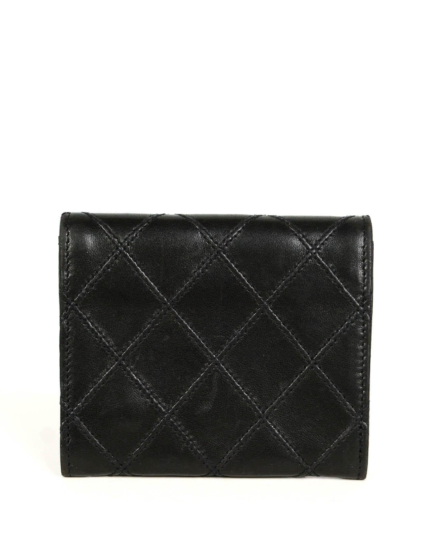 Chanel Black Lambskin Leather Quilted Card Case Wallet

Made In: France
Year of Production: 1994-1996
Color: Black
Hardware: Goldtone
Materials: Lambskin leather
Lining: Black grosgrain
Closure/Opening:  Flap top with snap
Exterior Pockets: