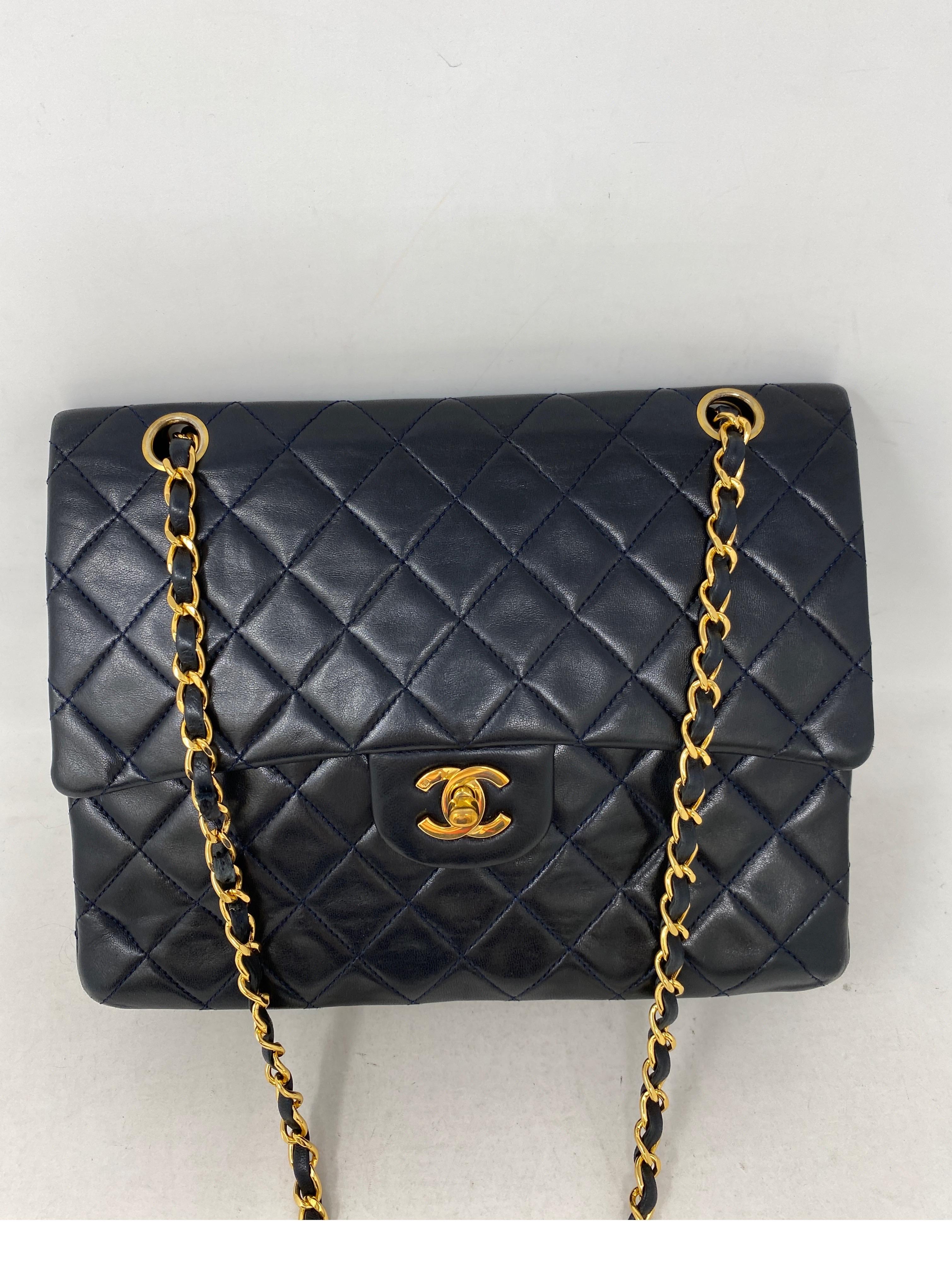 Chanel Black Vintage Double Flap Bag. Larger size. Gold hardware. 24 kt gold plating on hardware and chain strap. Excellent condition for a vinatge bag. Lambskin leather. Interior clean. Guaranteed authentic. 