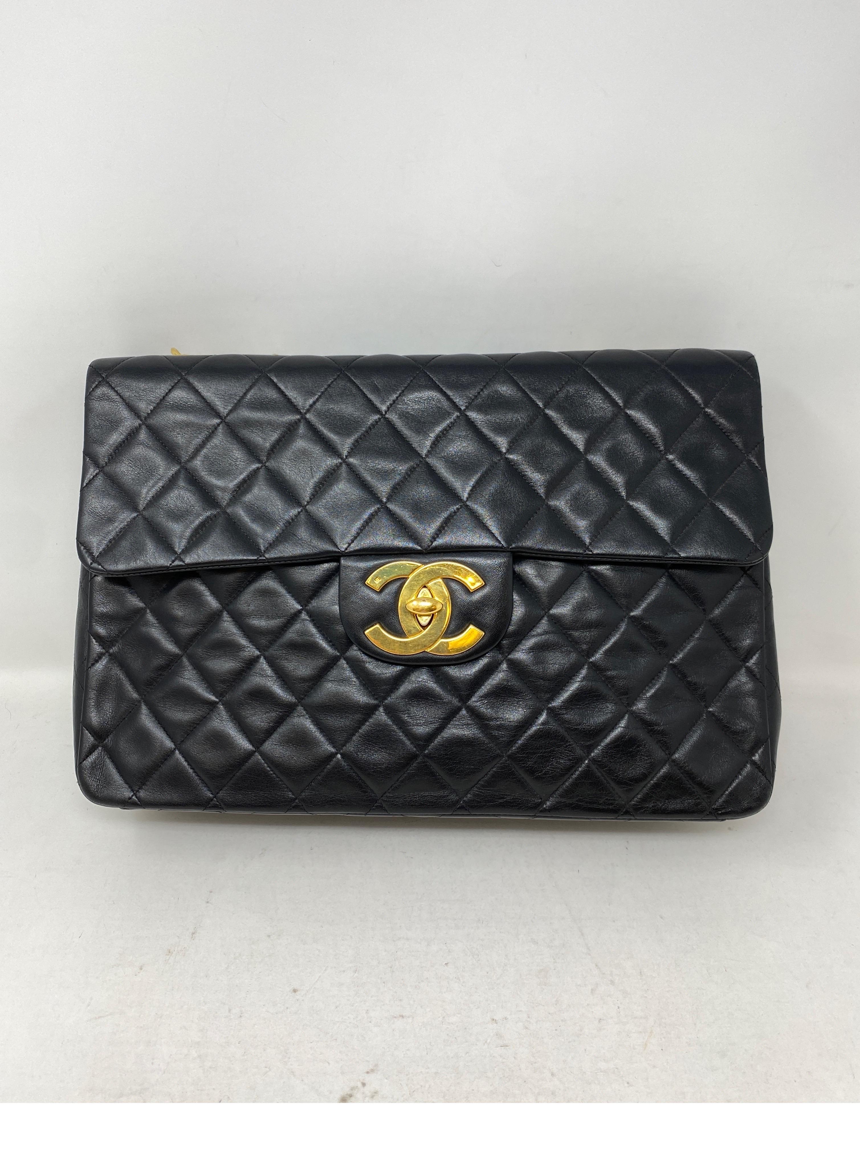 Chanel Black Vintage Maxi Bag. Karl Lagerfeld designed big CC clasp. 24 kt gold plated hardware and chain. Iconic design. Black lambskin leather. Can be worn as a crossbody or as a shoulder bag. Beautiful Chanel bag. Great investment. Guaranteed
