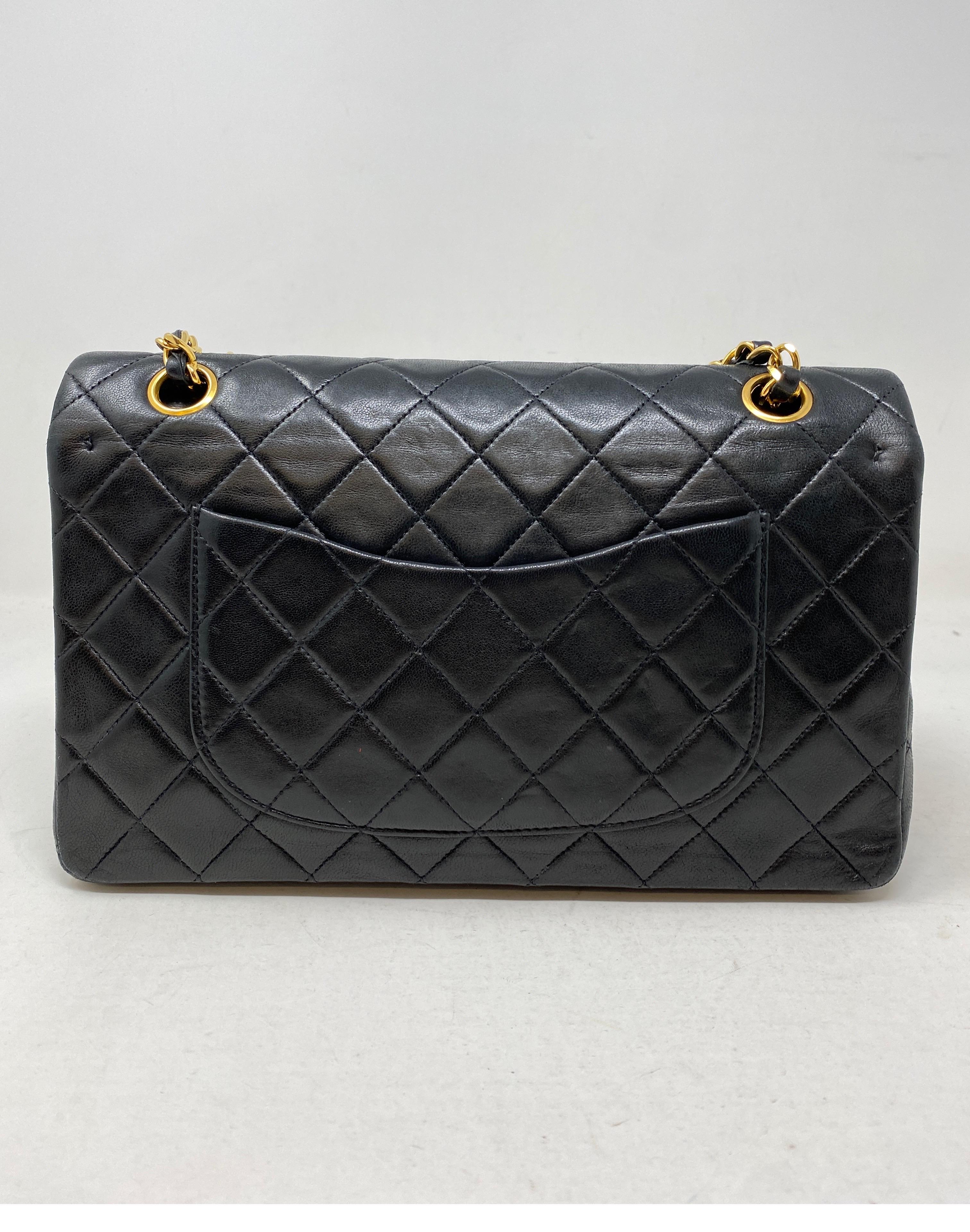 Chanel Black Vintage Double Classic Bag. Medium size. Lambskin leather. 24 kt gold plated vintage chain and CC closure. The most classsic Chanel bag. Burgundy leather interior. Guaranteed authentic. 