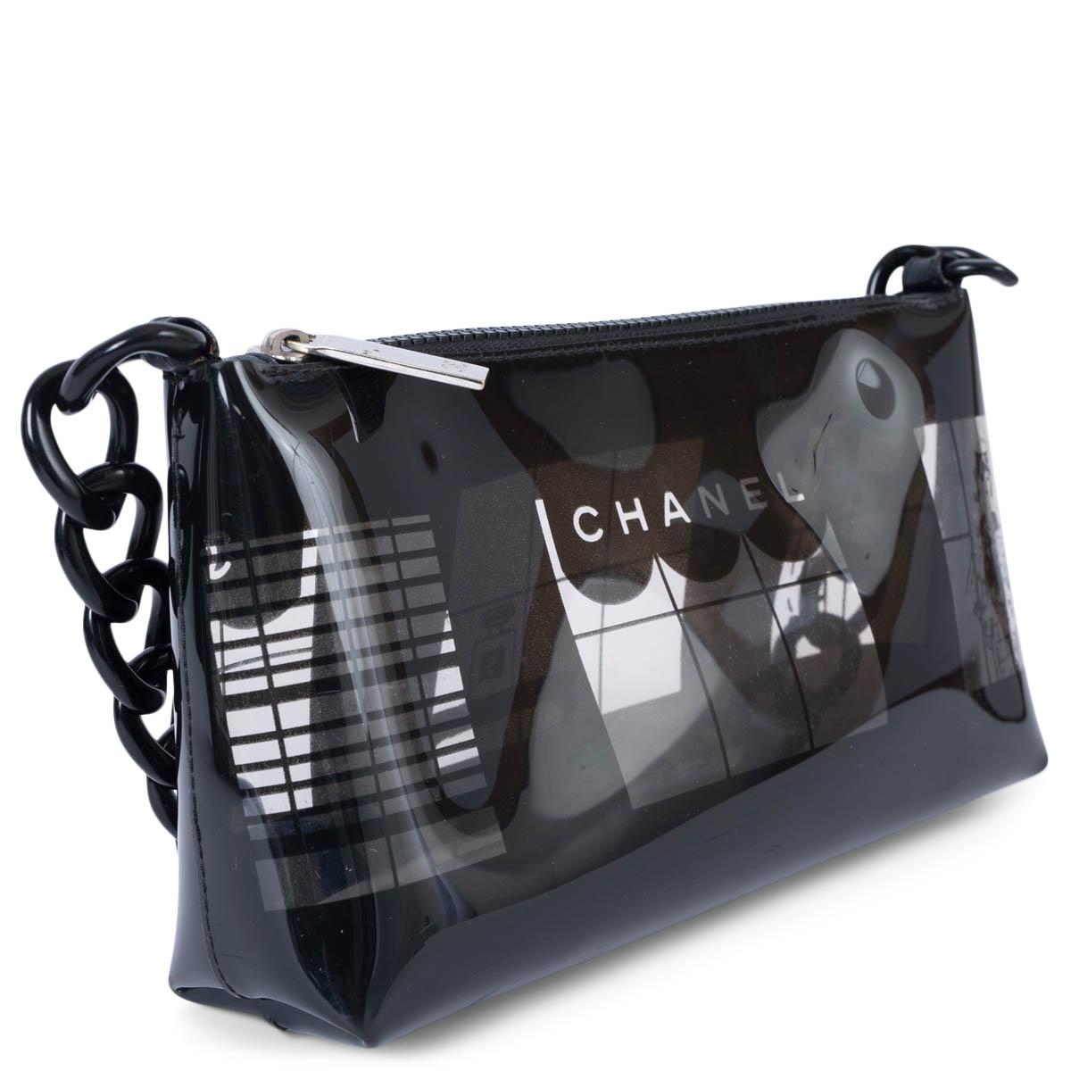 100% authentic Chanel clear and black vinyl Coco Window pochette. Opens with a zipper on top and features a black plastic chain strap and whimsical window scene design. Unlined. Comes with inside pouch. Has been carried and is in excellent