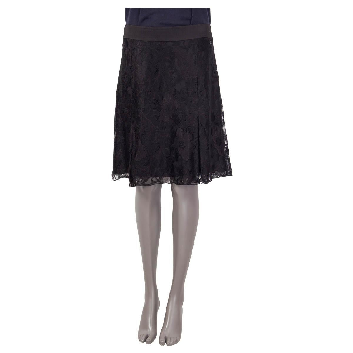 100% authentic Chanel box pleat lace skirt in black viscose (60%) and nylon (40%). Features a black 'CC' logo on the front. Opens with a concealed zipper and a hook on the back. Lined in black silk (100%). Has been worn and is in excellent