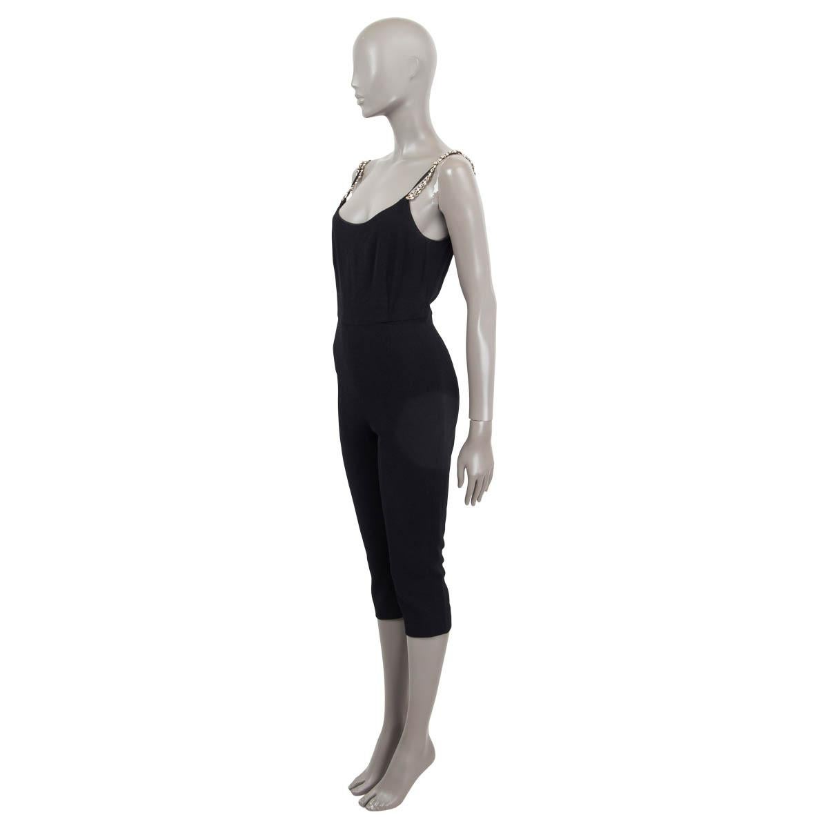 100% authentic Chanel 2019 knee length jumpsuit in black viscose and elastane (assumed cause tag is missing). Features pearl and chain embellished straps. Opens with a zipper and a hook on the back. Lined in black silk (assumed cause tag is