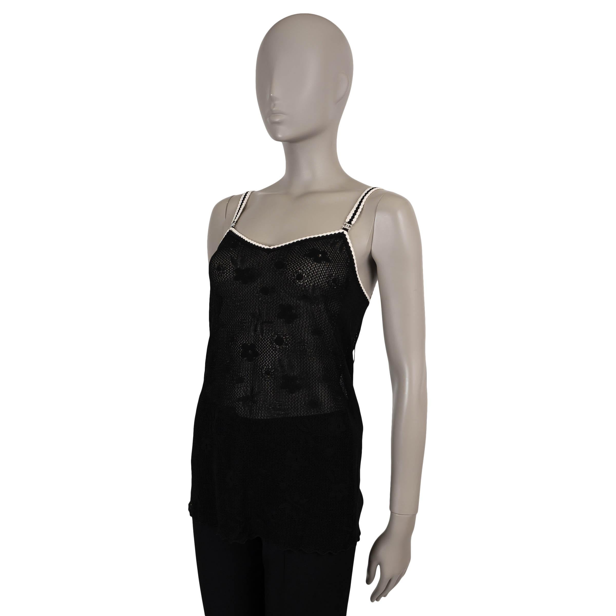 This 100% authentic Chanel tank top in black loose-knit viscose (76%) and polyamide (24%) showcases exquisite craftsmanship with all-over floral embroidery and delicate cream trim. Designed with a flattering fit-and-flare silhouette, it features