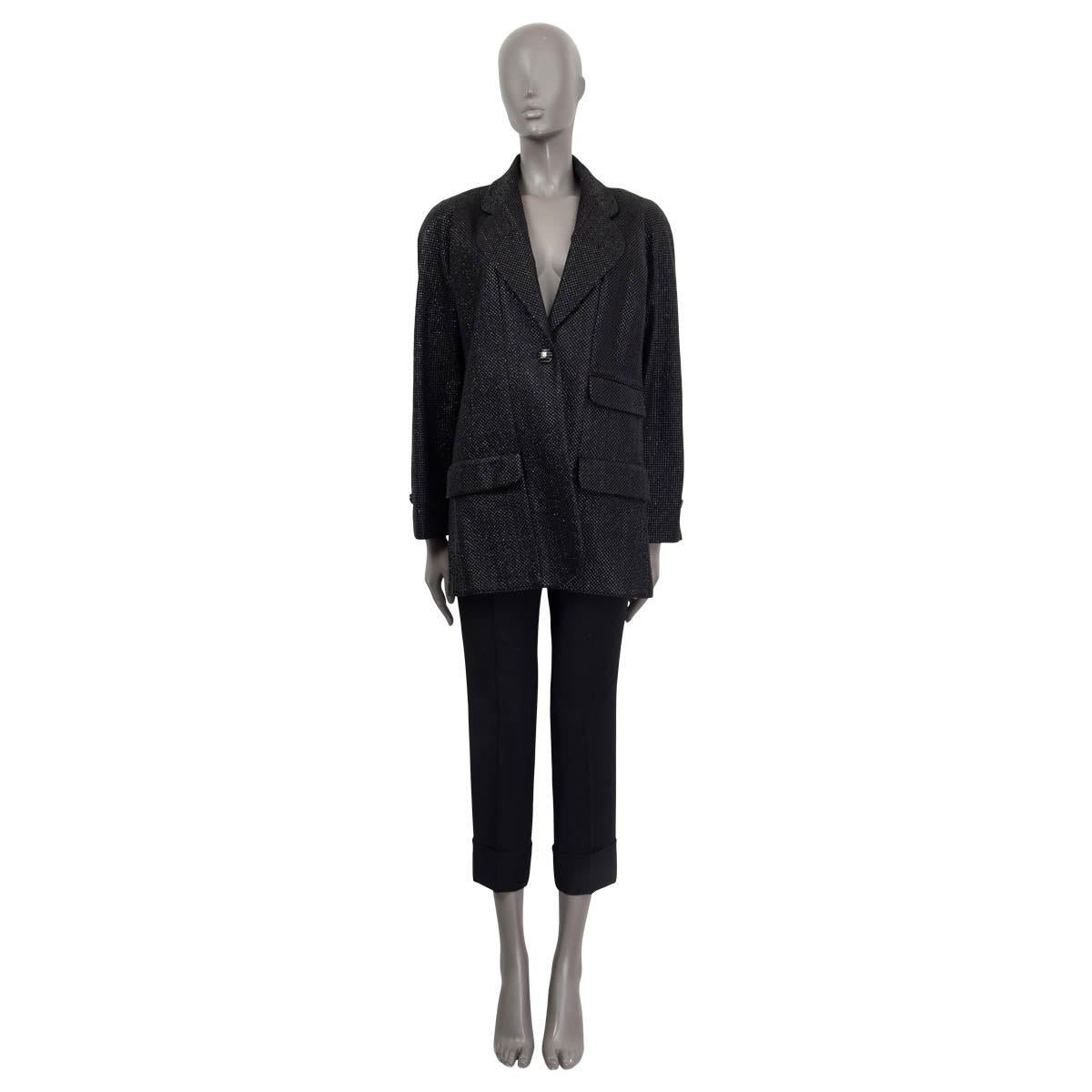 100% authentic Chanel single breasted one button blazer with round notch lapel in black shiny net fabric (viscose 60%), silk (25%) and polyester (15%) with classic logo printed black lining silck (100%) and gunmetal chain on the inside hemline.