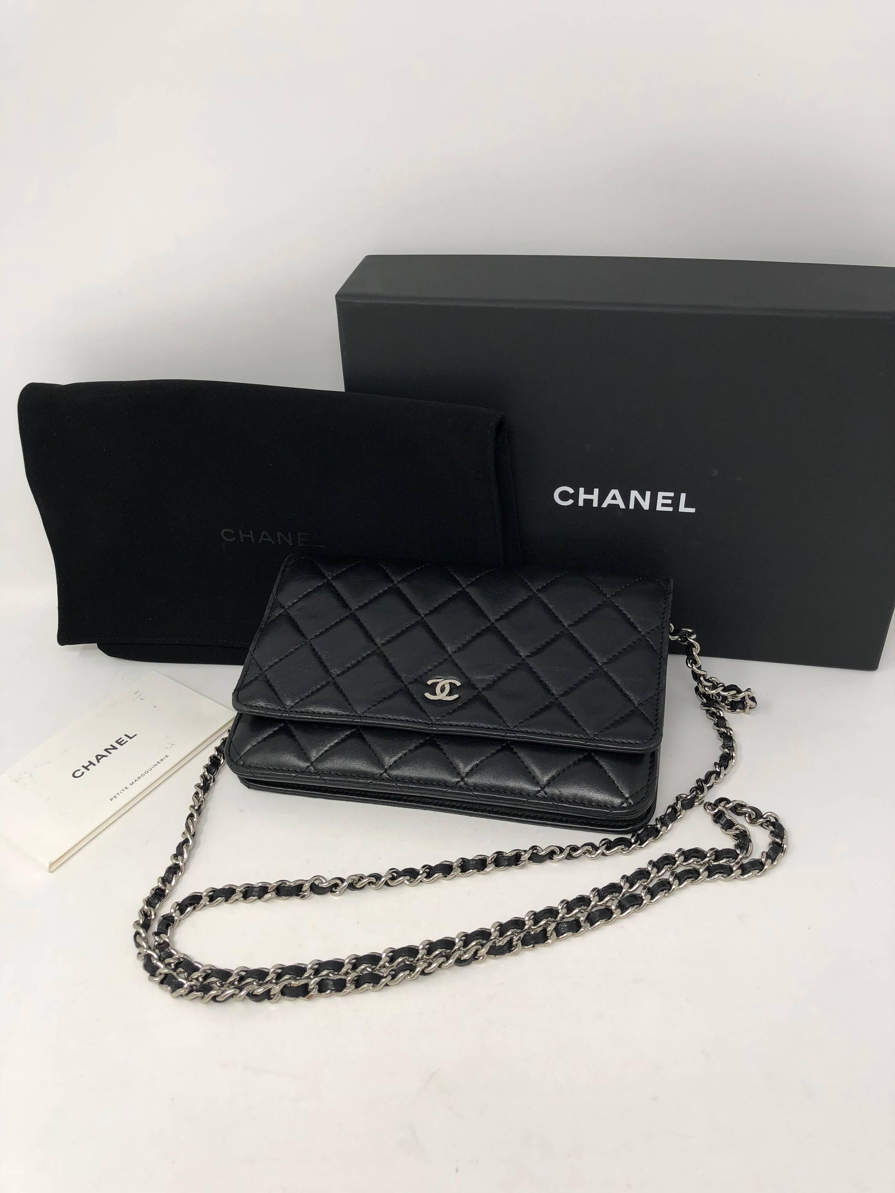 Black Chanel Wallet on Chain Crossbody in lambskin. Silver hardware in mint condition. Comes with dust cover, authenticity card, and original box. Wallet bag can hold several cards and even a phone. Great day to evening bag. Guaranteed authentic.