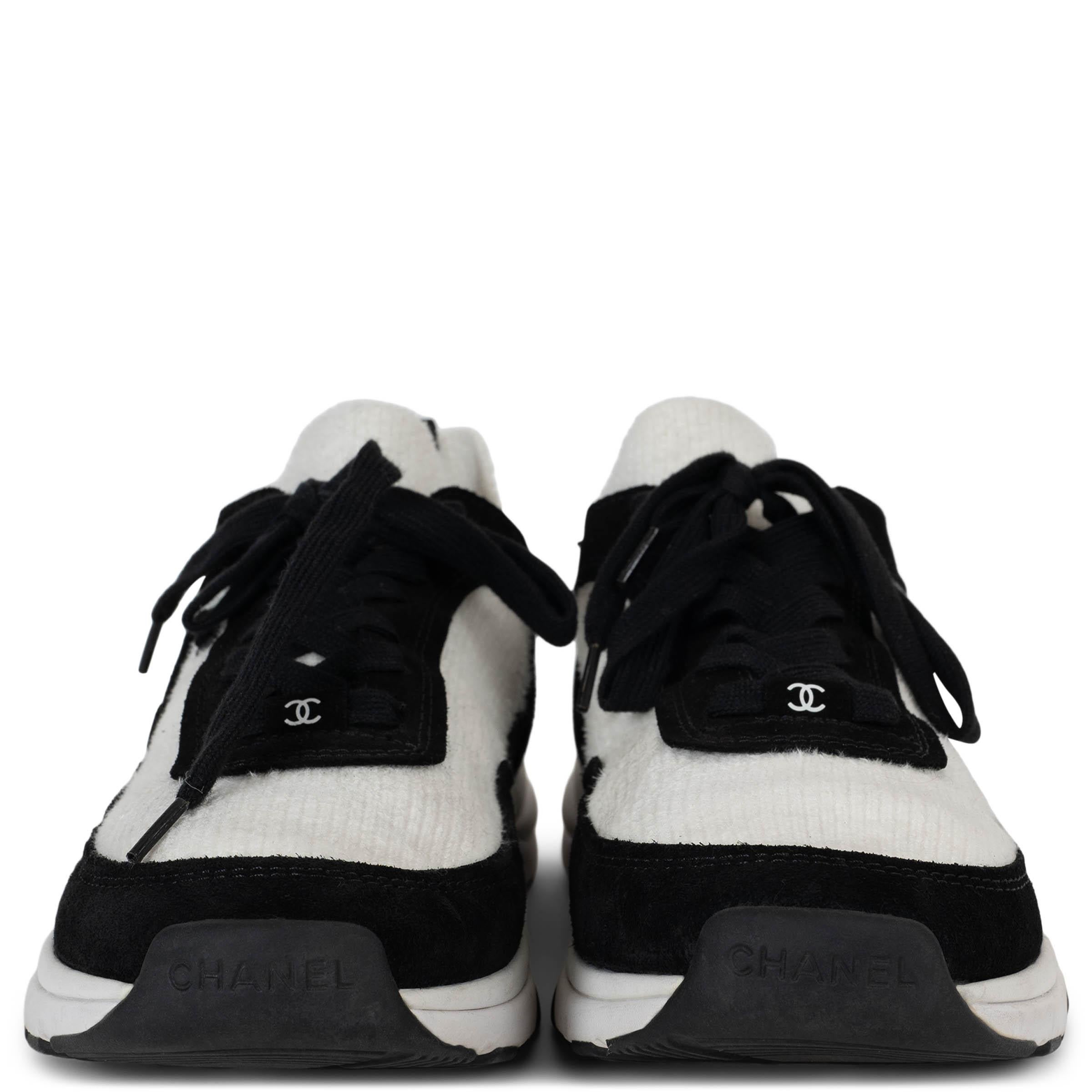 This 100% authentic Chanel low-top sneakers in white knit blend modern comfort with timeless elegance. Accented with black suede trims, they feature rounded toes and a suede CC on the outsides for a subtle yet iconic touch. A tonal signature on the