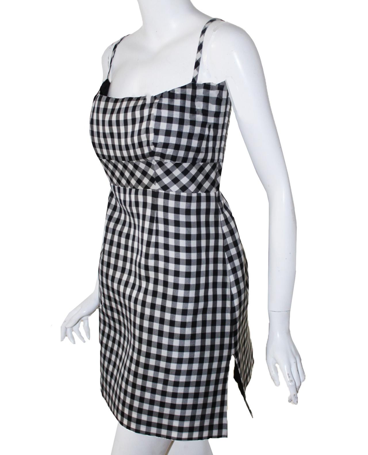 Chanel black and white gingham check summer silk dress includes spaghetti straps and a zipper at the side for closure.   This dress contains a vent at one side and is fully lined in black silk organza.  This dress was professionally altered, so