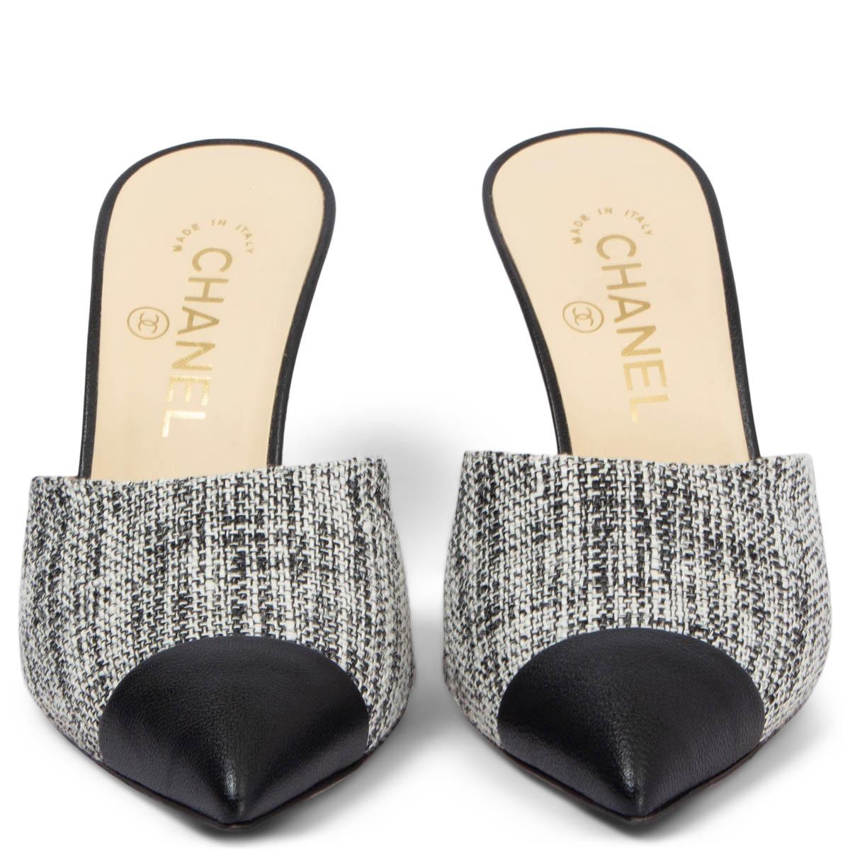 100% authentic Chanel pointed-toe mules in black, grey and white tweed with black goatskin cap toe and heel embellished with an off-white faux pearl. Have been worn once or twice and show a very faint dent on the left heel. (barley visible). Come