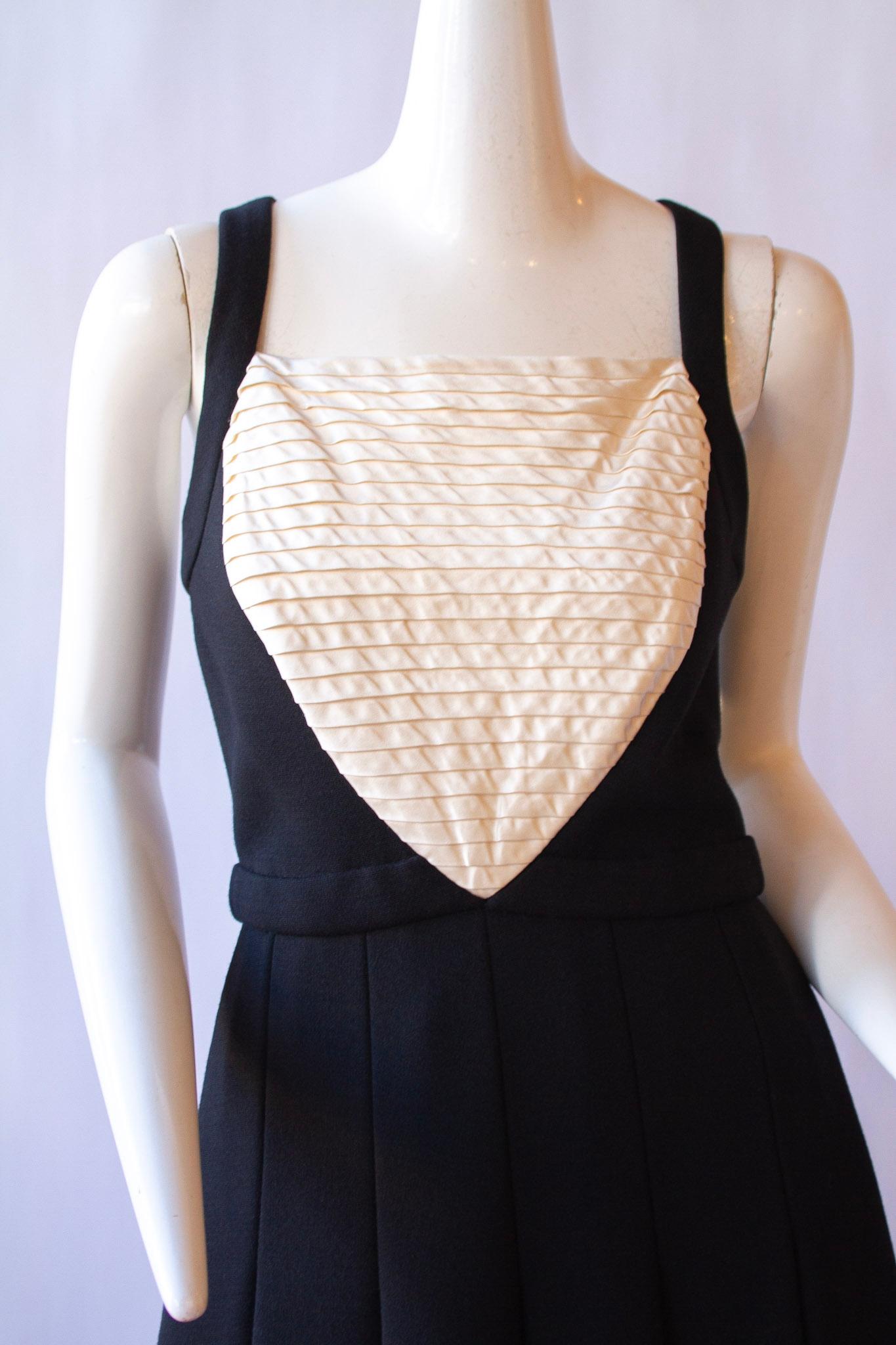 Chanel halter tuxedo dress, pleated chest, back cross-straps, A-line flounce skirt. Wool

Sz 6/Med