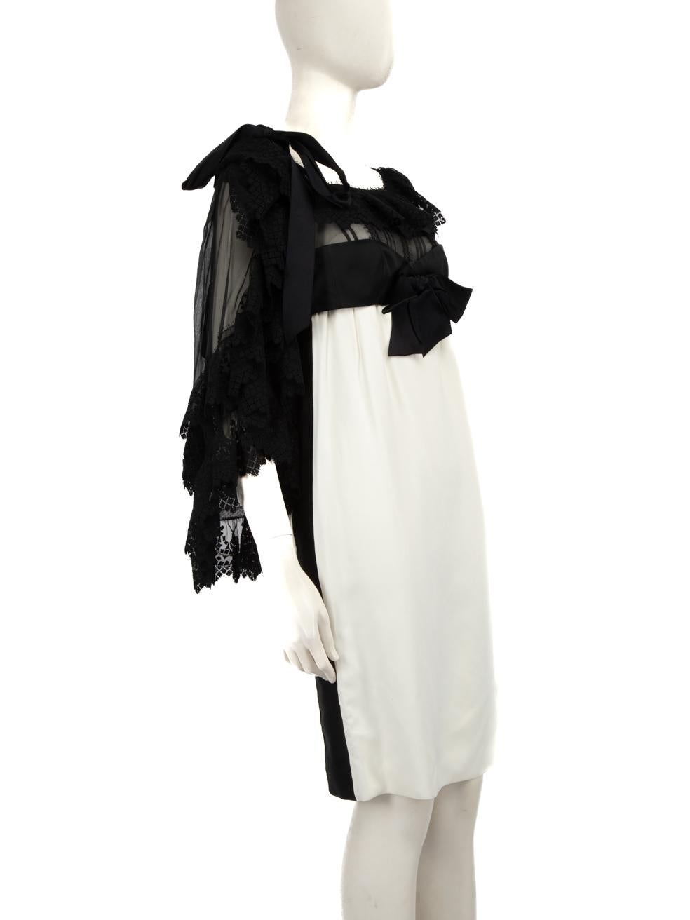 CONDITION is Good. Minor wear to the dress is evident. Discolouration, on the inside designer label, across the lower half of the dress on the front and back and on the inner back neck. Pulls to the weave on the shoulder bow, across the bow waist
