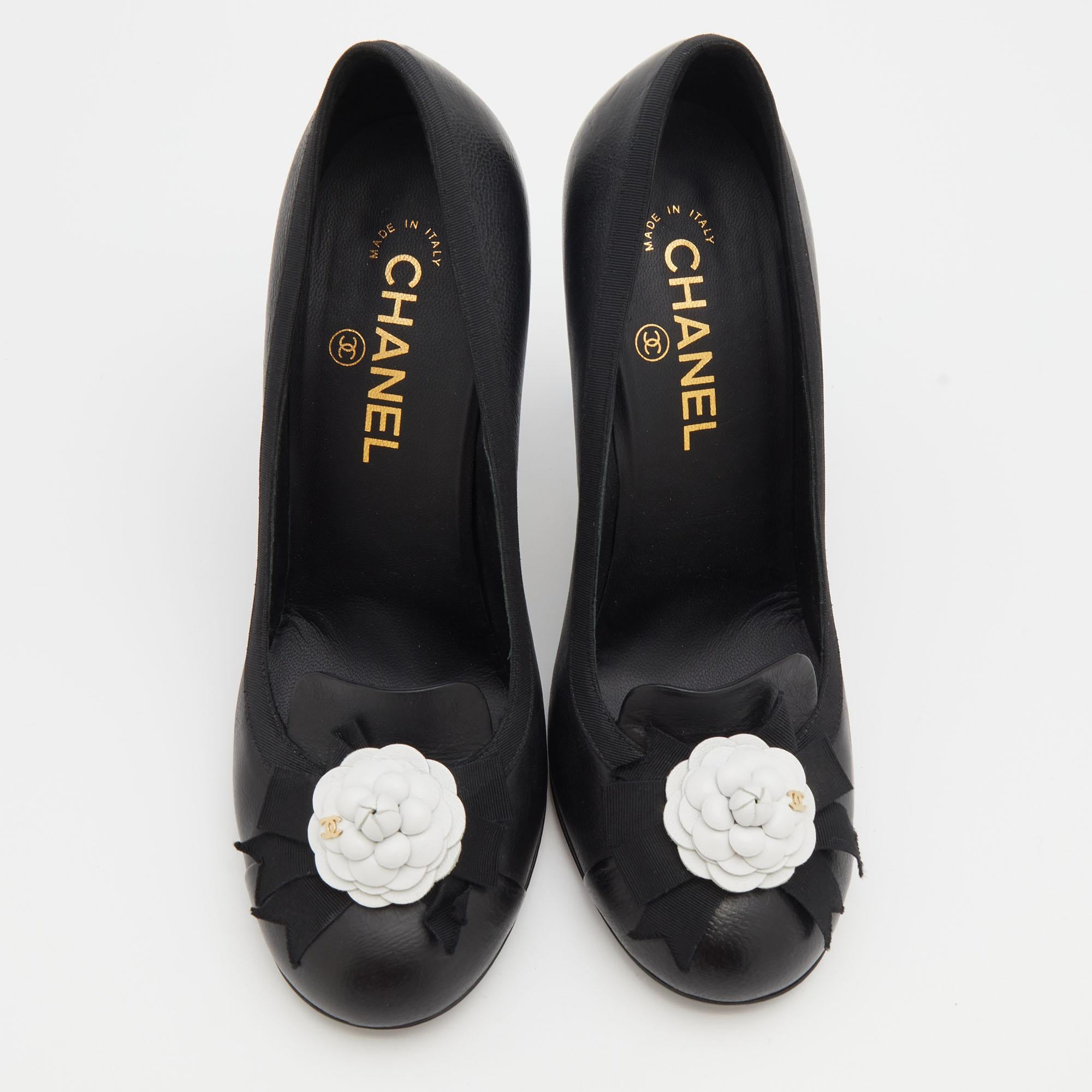 This pair of pumps from the house of Chanel is just what you need to take your style quotient a few notches higher. Made from smooth black leather, their versatile design features round toes with vamps embellished with the signature Camellia flower