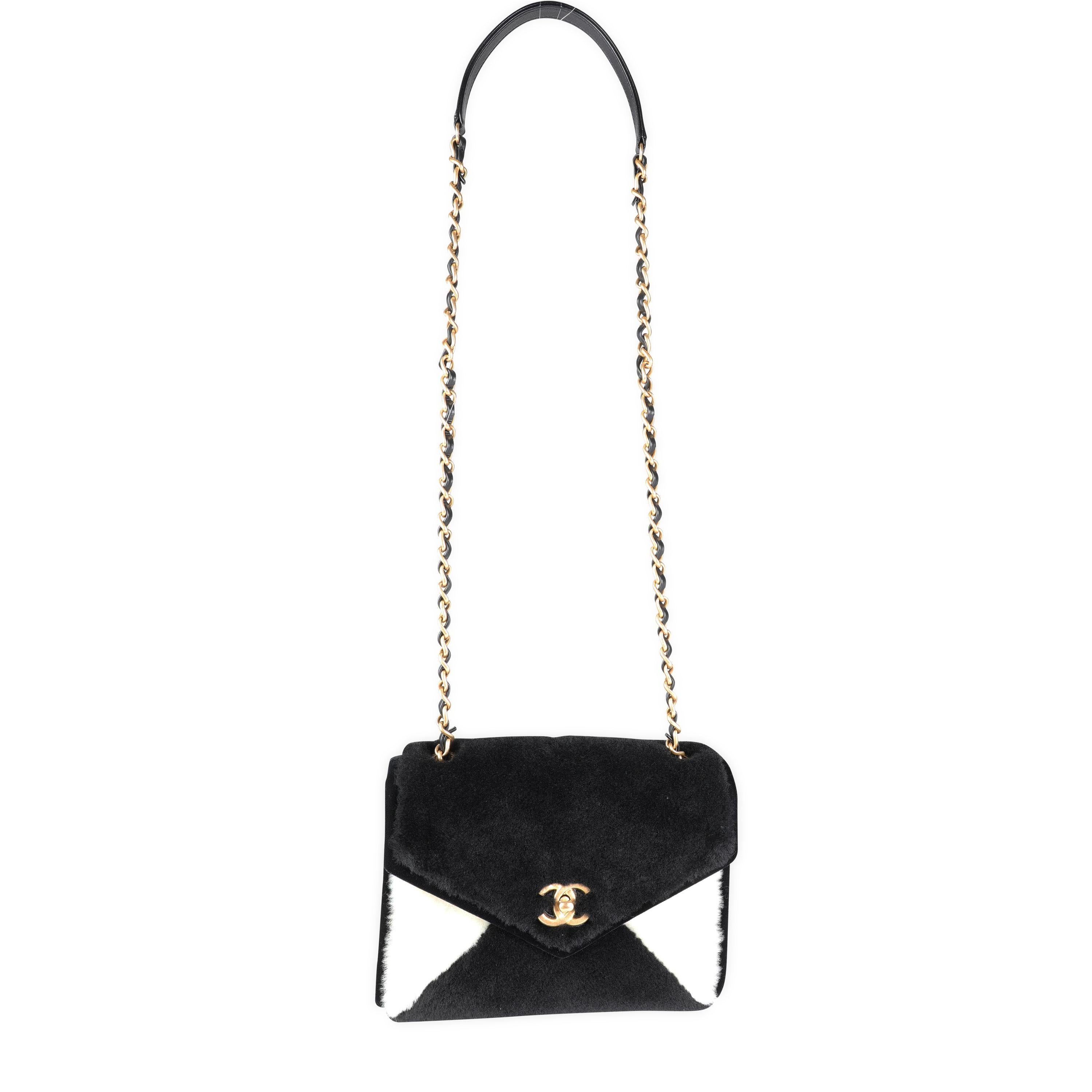 Listing Title: Chanel Black & White Shearling Small Single Flap Bag
SKU: 115789
Condition: Pre-owned (3000)
Handbag Condition: Excellent
Condition Comments: Excellent Condition. Plastic on some hardware. Two faint scuffs under flap. No other visible