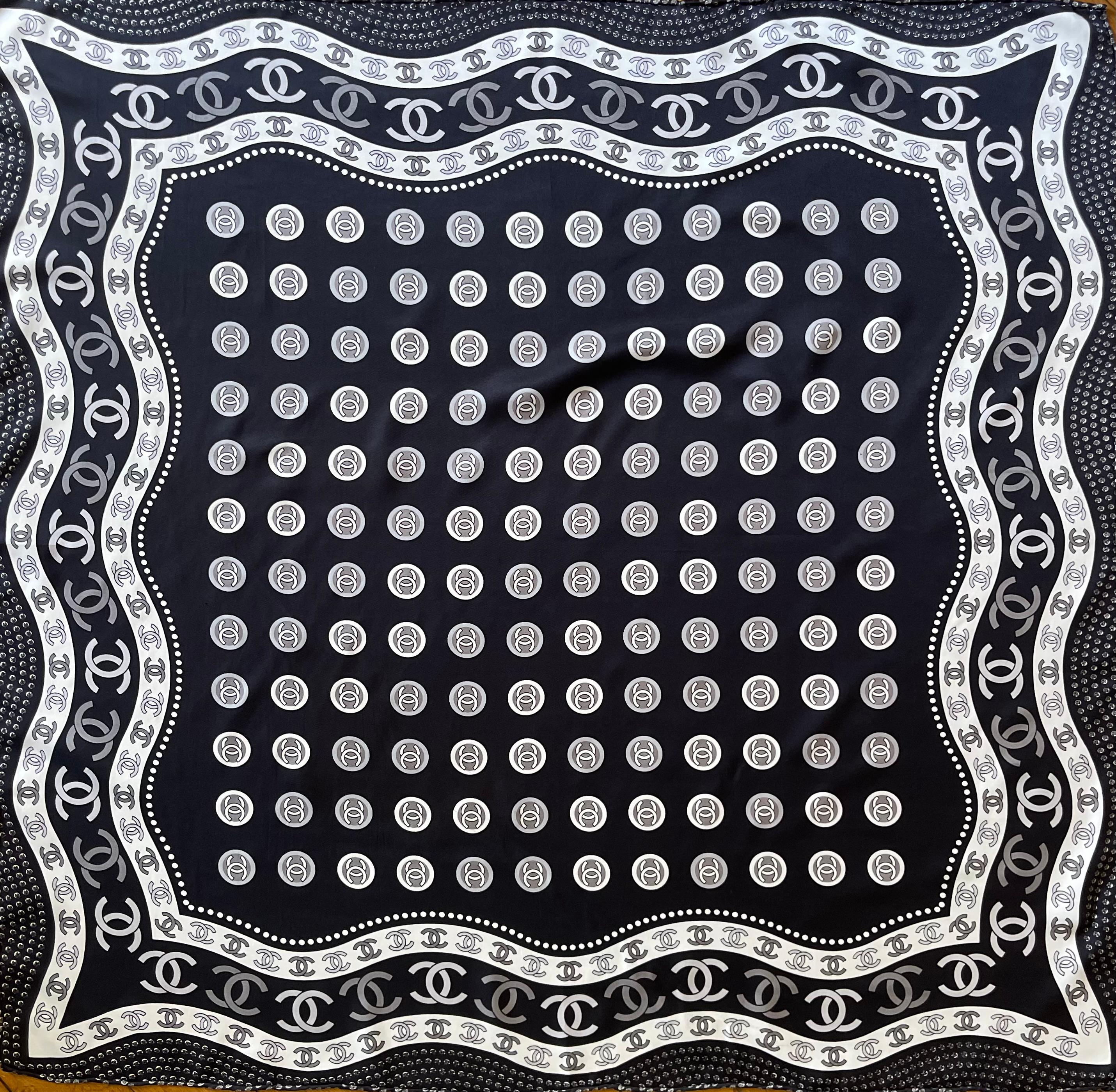 Chanel Black & White Silk Scarf CC Logo. Please note this item is in good condition with minor wear consistent with age and use. This beautiful scarf is a perfect representation of the brands classiness and timeless pieces. The colors are vibrant,